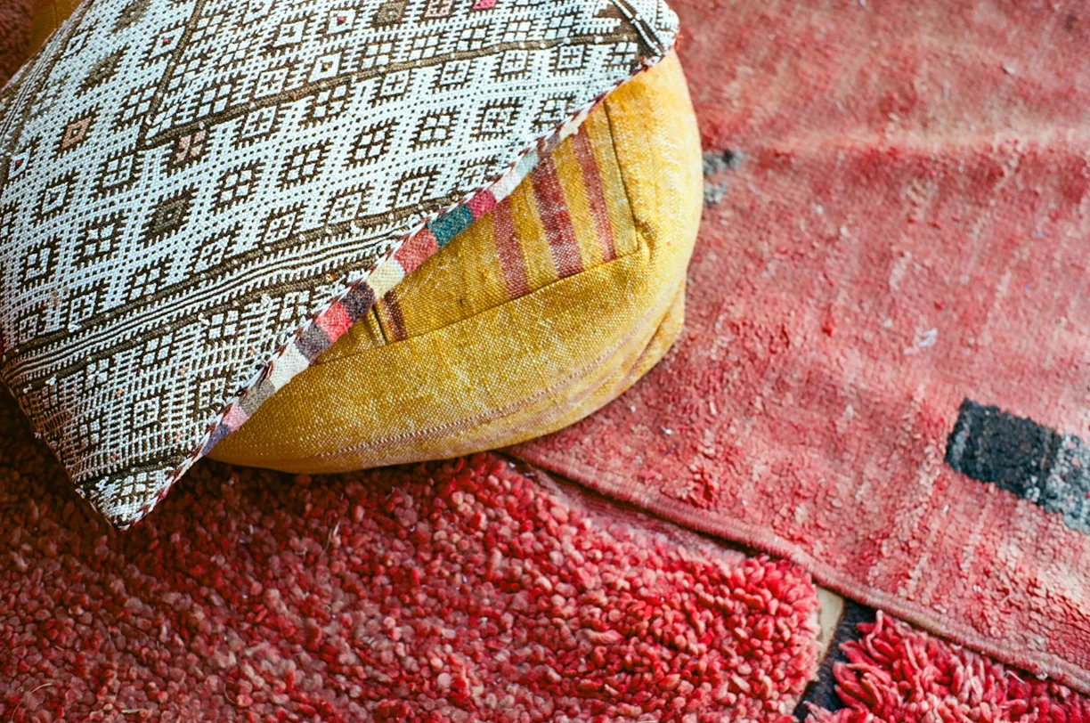 Pillows and red rug by tent_sahara luxury desert camp_web.jpg