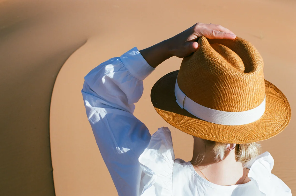 Allison in Focus Holding Hat_Curve in the sand_Sahara Desert_web.jpg