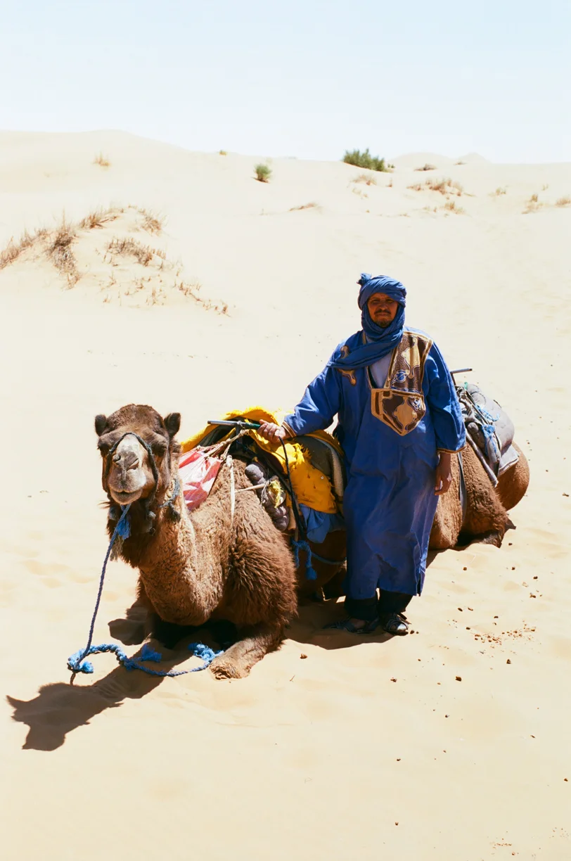 Camel Guide with Seated Camel in Sand_web.jpg