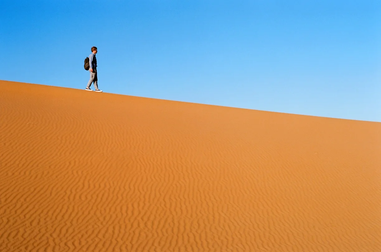 Cole Walking on Edge of Dune Line_Sahara Desert_web.jpg