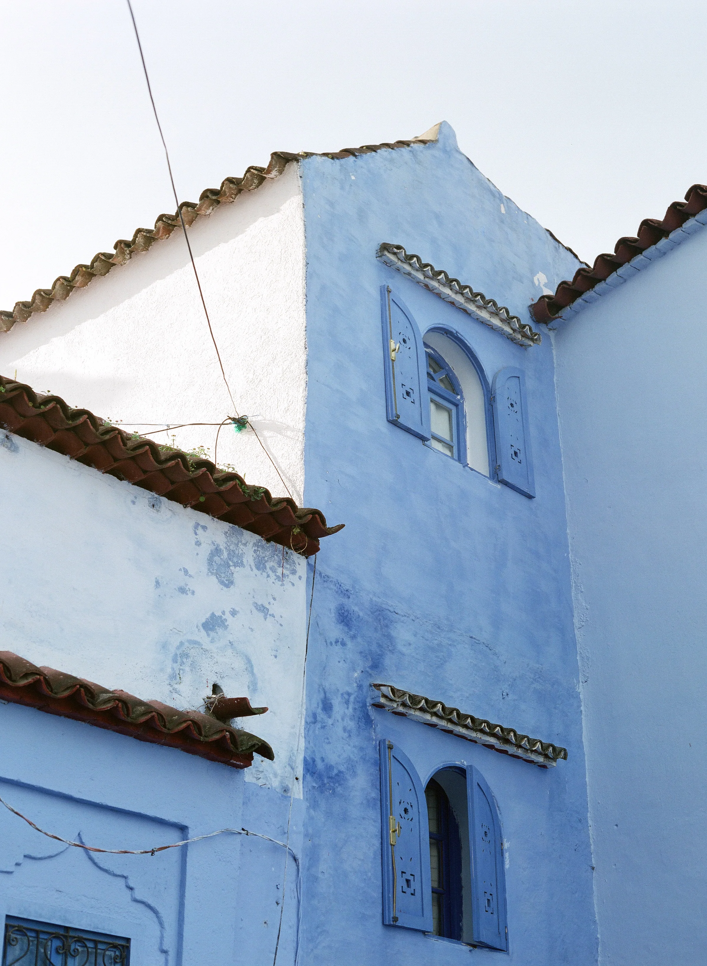 Two Windows and Wire on Building in Chefchaouen.jpg