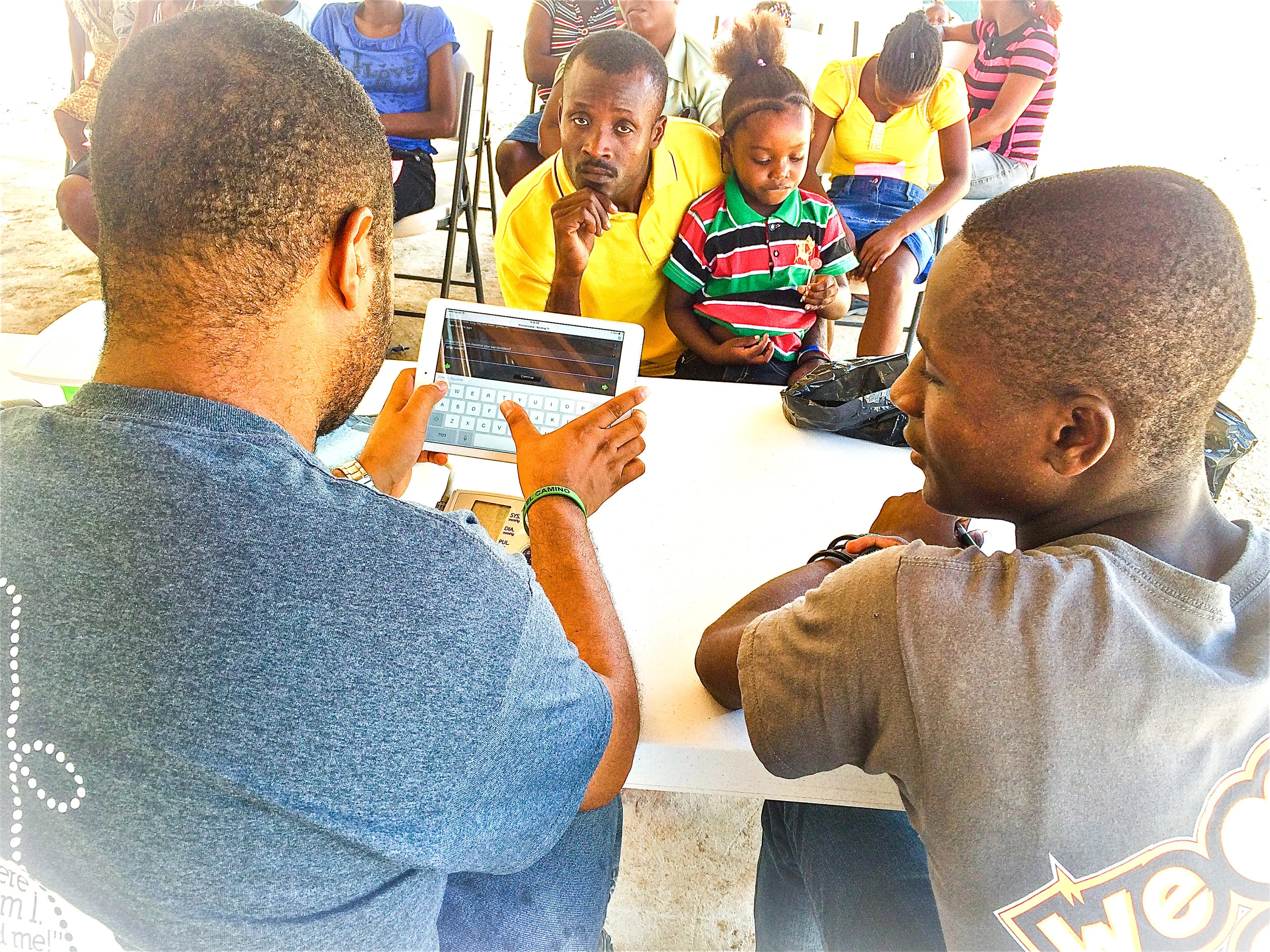 Children of Batey Central holding hands in the area of where the clinic will be built