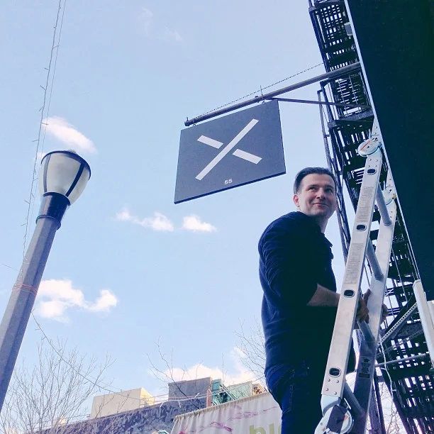 Up on a ladder at Jnrlstr, at 55 Clinton Street inspecting the new sign. ©KristinSloan via Instagram