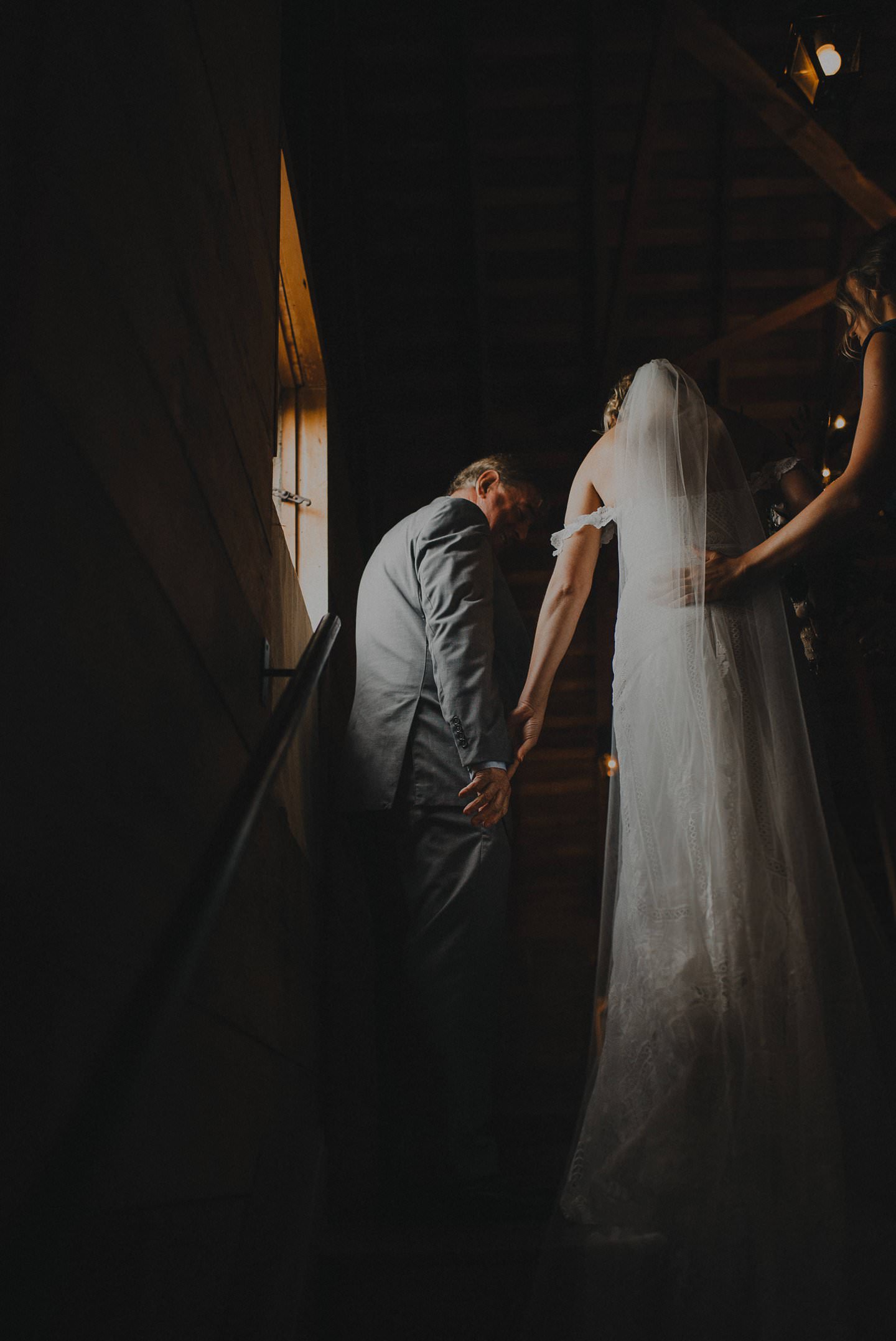 Dramatic shot of bride and her father walking down the aisle