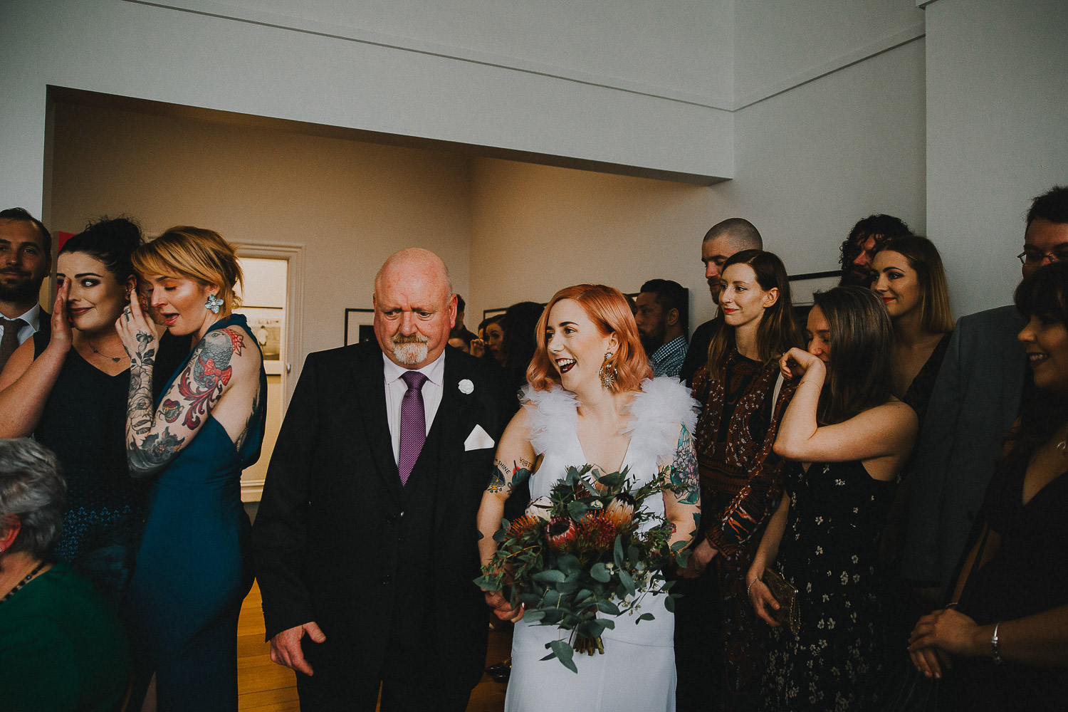 Alternative tattooed bride walking down the aisle