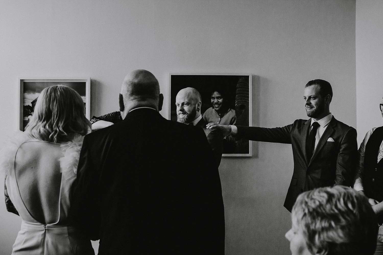 Emotional photo of groom as his bride walks down the aisle