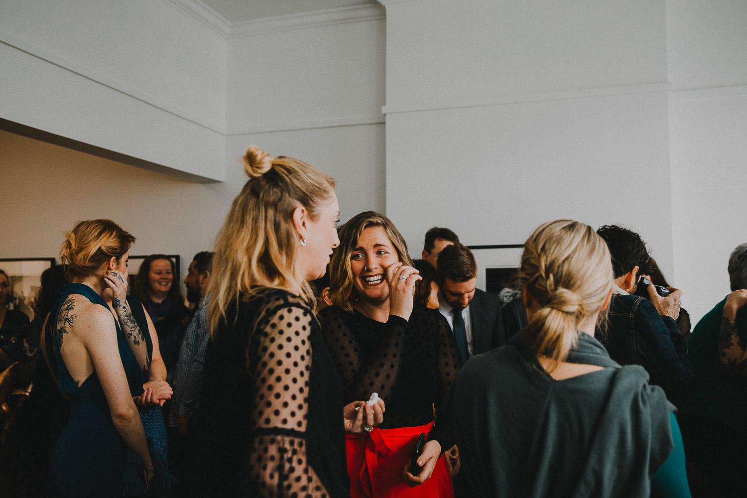 Guests mingling at modern art gallery wedding