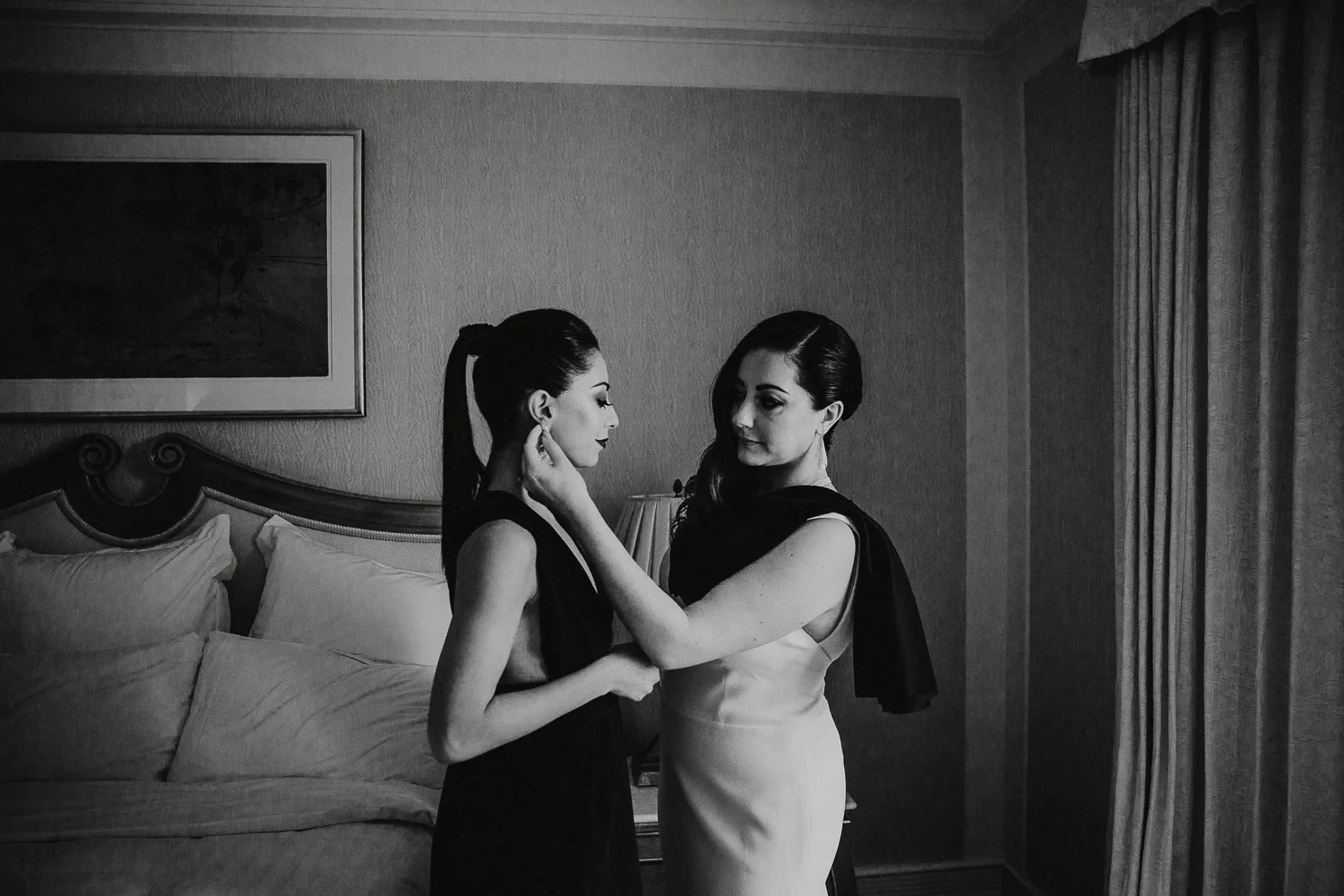 Bride and bridesmaid getting ready