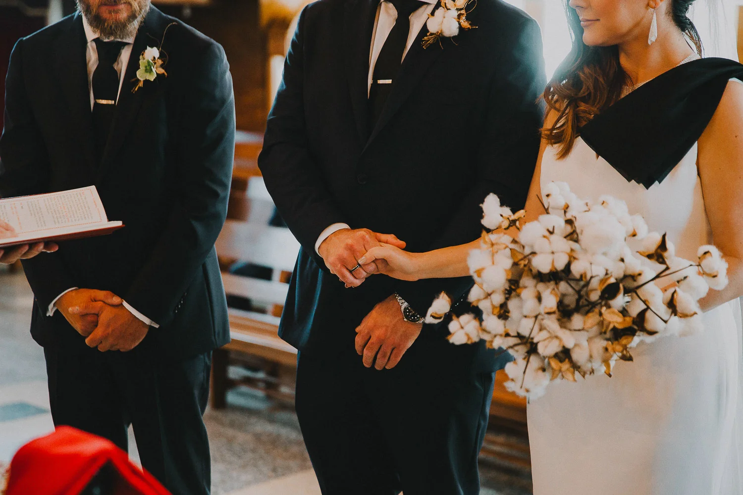 The birde and groom holding hands during the wedding ceremony