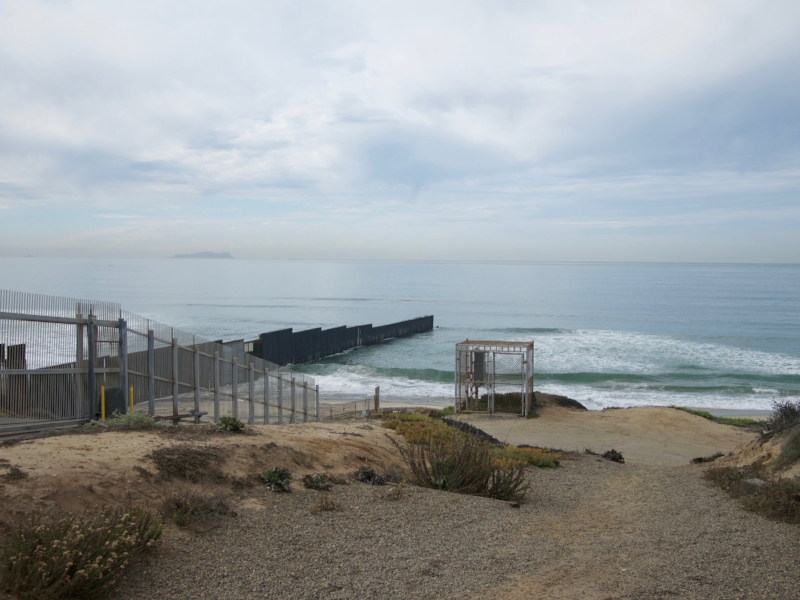 looking at the border fence going into the pacific ocean