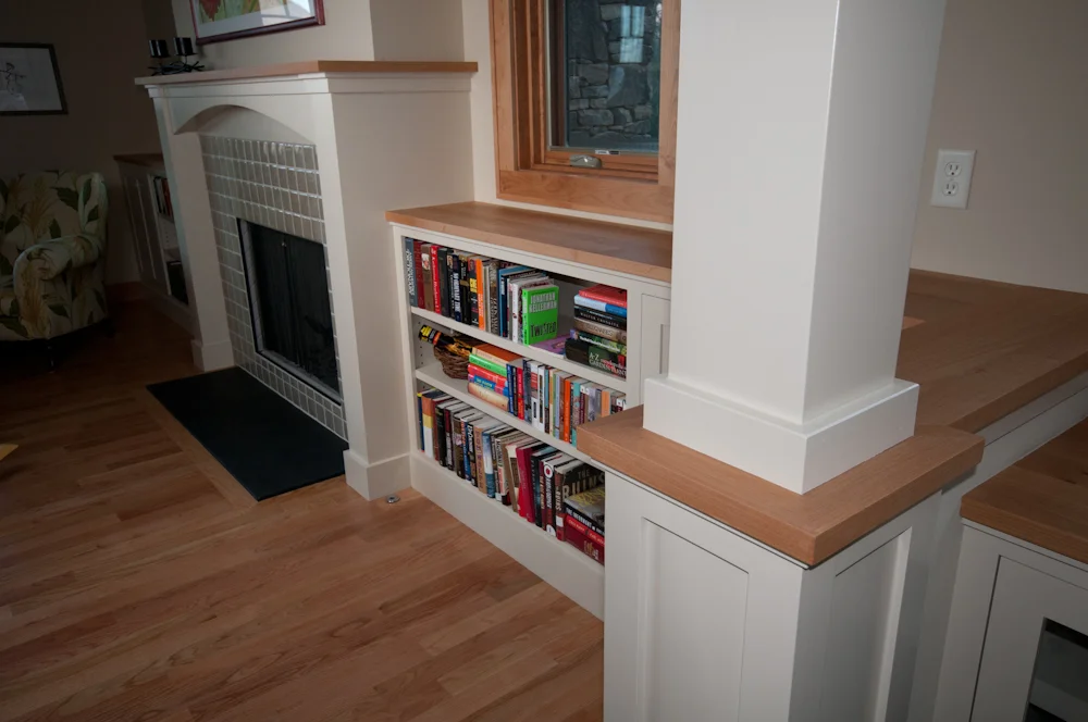 Bookshelves that Flank Fireplace. Painted poplar bookshelves, painted poplar fireplace surround, painted poplar columns, hard maple tops, handmade ceramic tile around fireplace, and slate hearth.