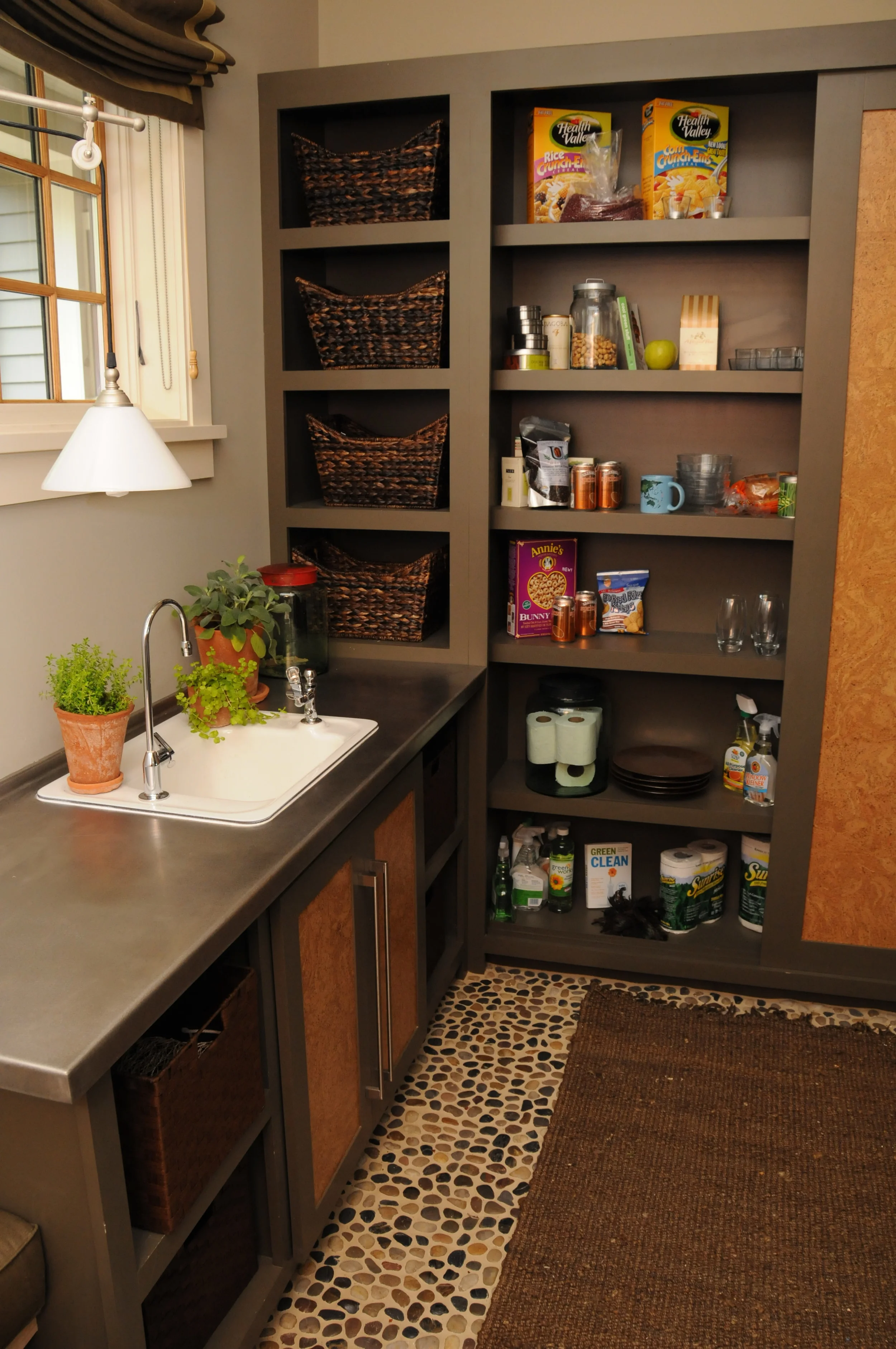 Detail of Pantry/Mudroom at Southern Living Idea Home at Davidson Gap. Painted poplar cabinet, cork inlays in doors, river stone floors, and stainless counter (counter not done by Breitzke Carpentry ). 