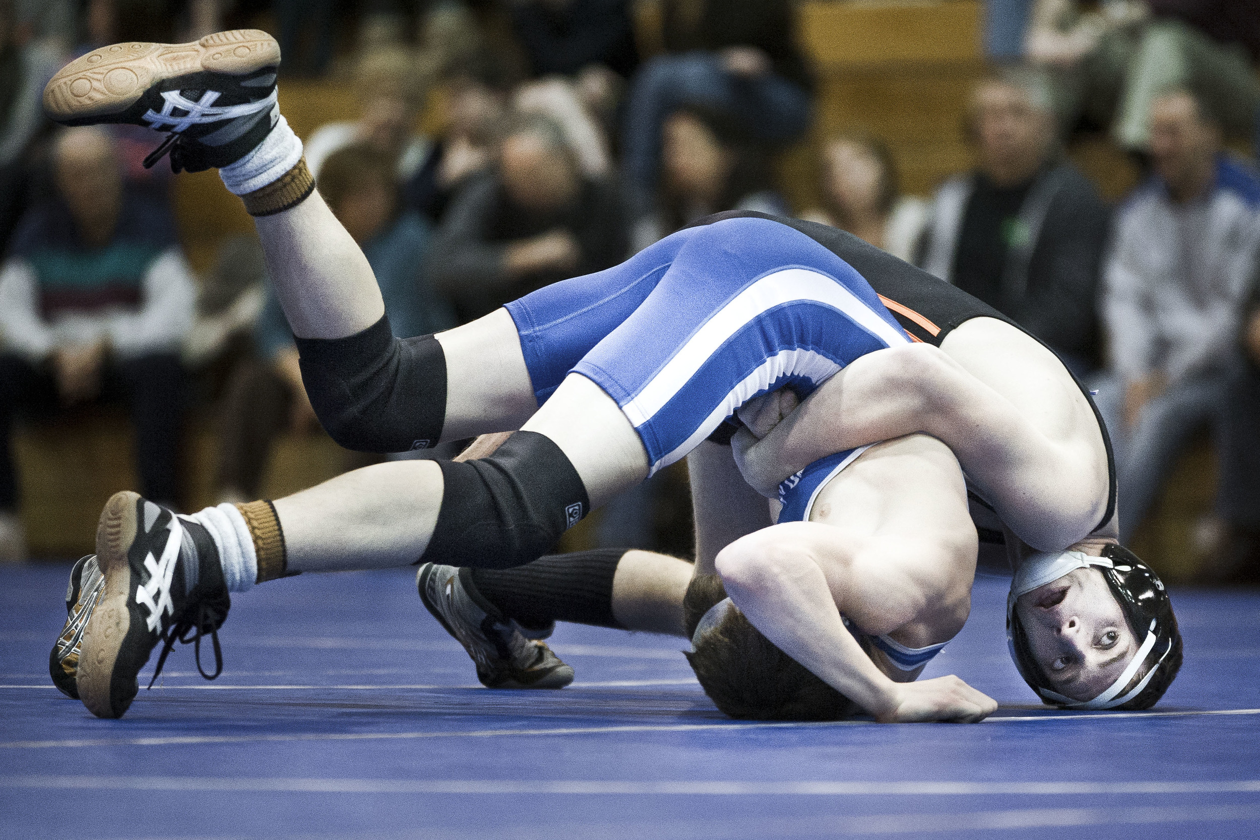 South Hadley's Chris Rojas tries to keep Granby's Clayton Yarneksy from flipping over during their match at Granby High School in Granby, Massachusetts.