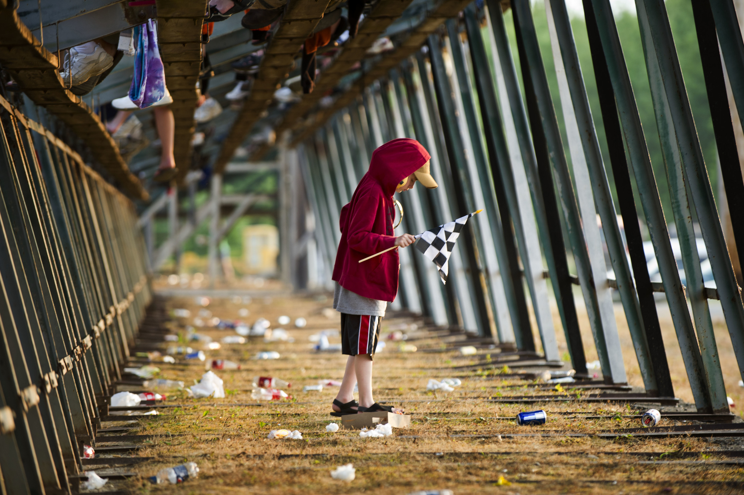 Ayden Haddad navigates through the garbage accumulated underneath the bleachers at Canandaigua Motorsports Park in Canandaigua, New York.