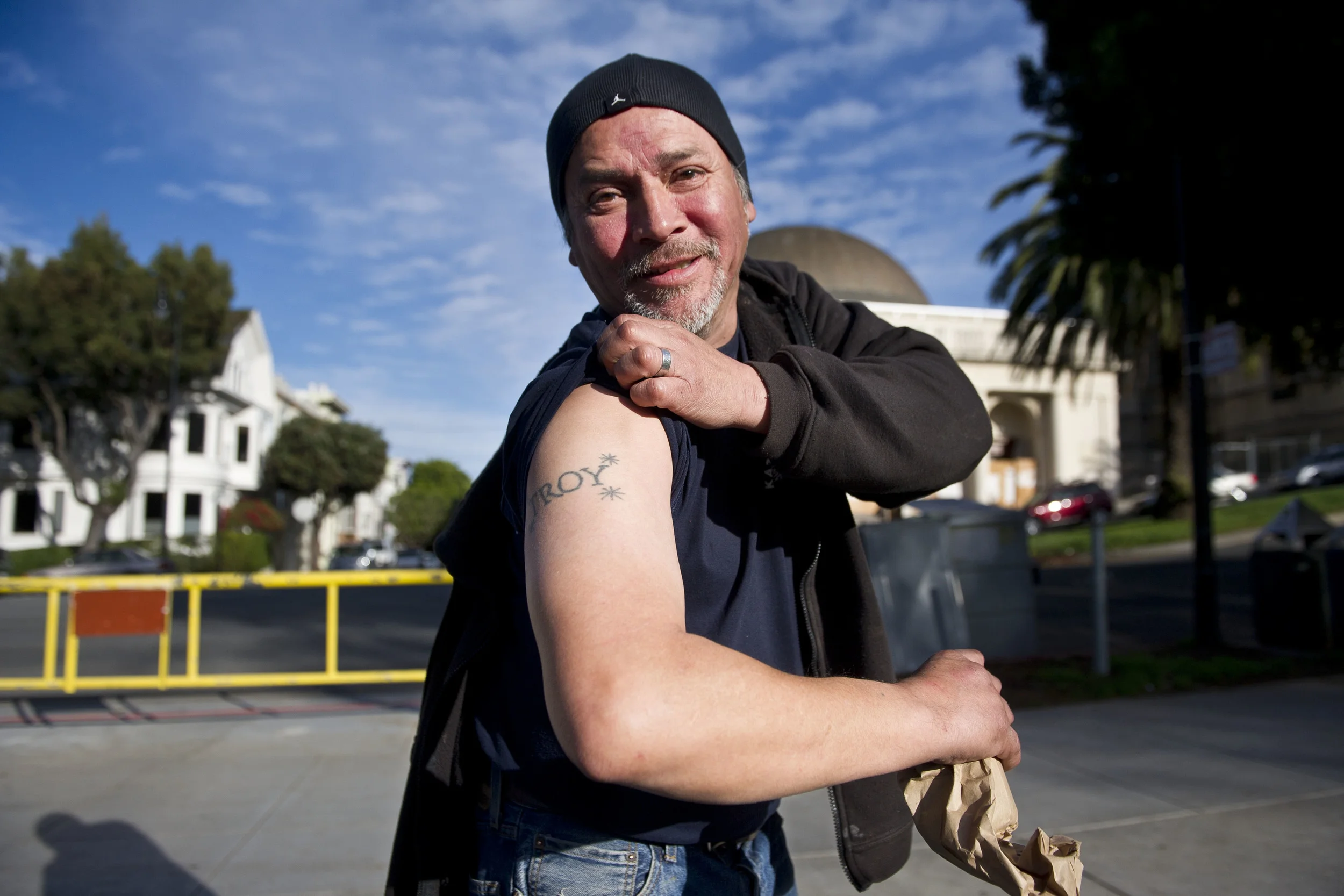 Jessie shows me his tattoo and asks for a nickel. San Francisco 2014