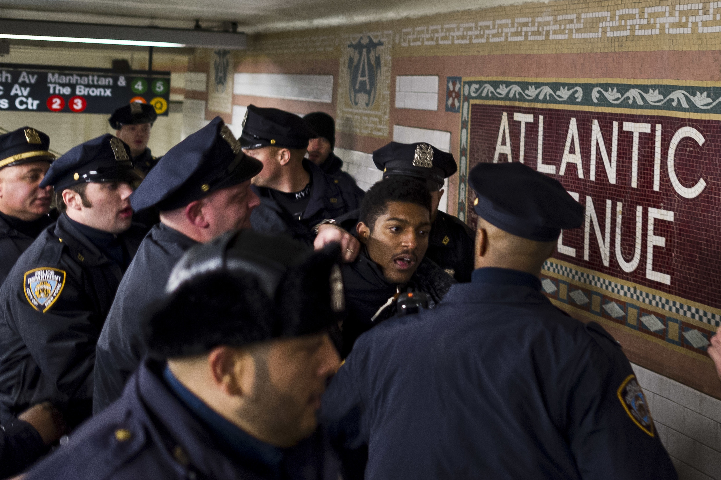  A dozen NYPD officers arrest a lone protestor after a heated standoff inside the Atlantic Avenue subway station in Brooklyn. 