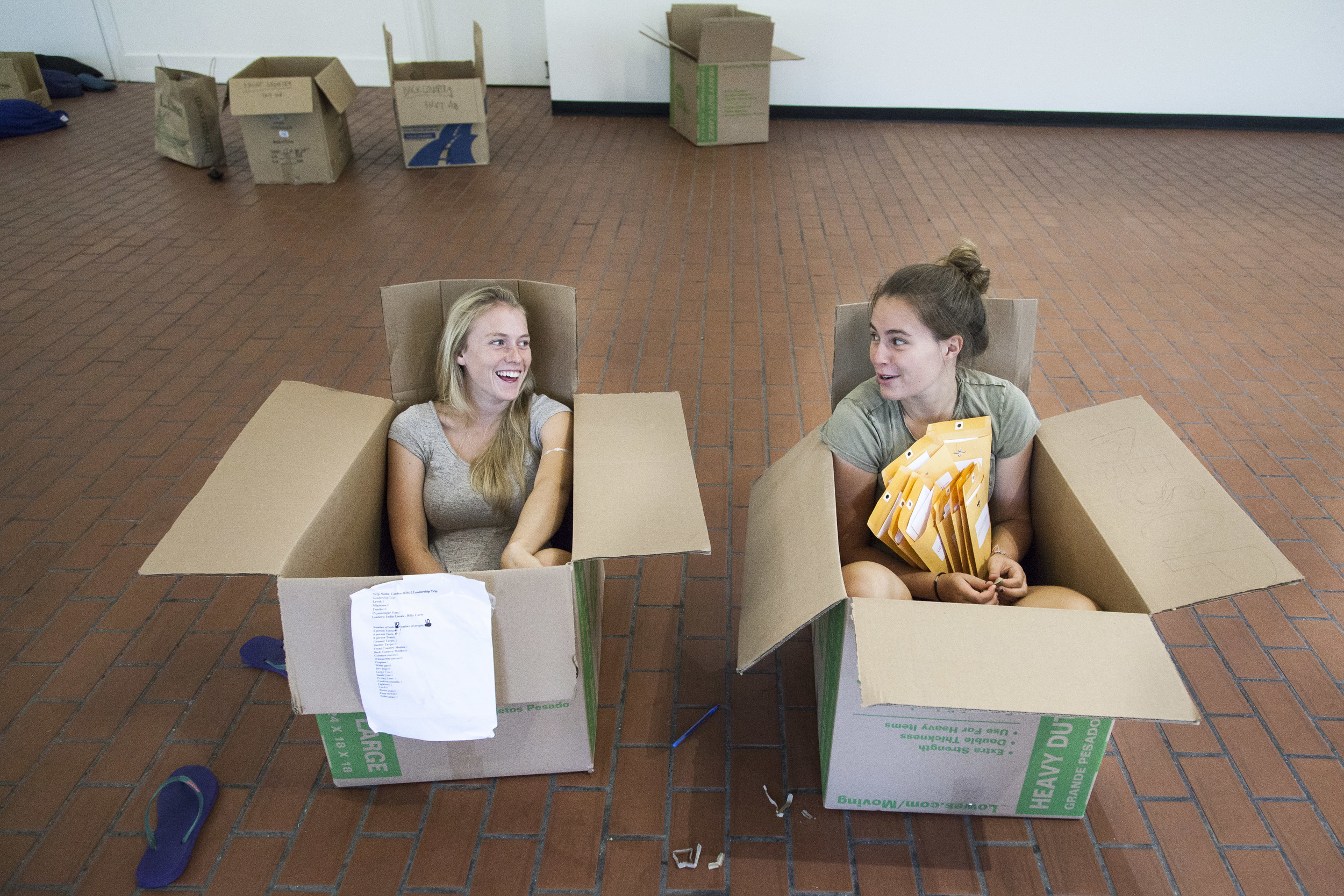 AESOP Coordinators Nat Silver '16 (L) of Bennington, Vermont and Sasha Lennon '16 (R) of Cape Elizabeth, Maine, find comfortable seating in which to distribute materials to trip leaders.    