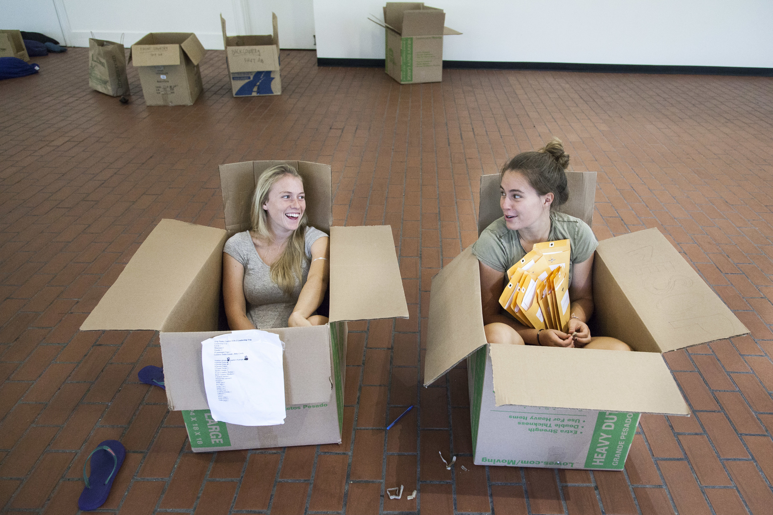 AESOP Coordinators Nat Silver '16 (L) of Bennington, Vermont and Sasha Lennon '16 (R) of Cape Elizabeth, Maine, find comfortable seating in which to distribute materials to trip leaders.