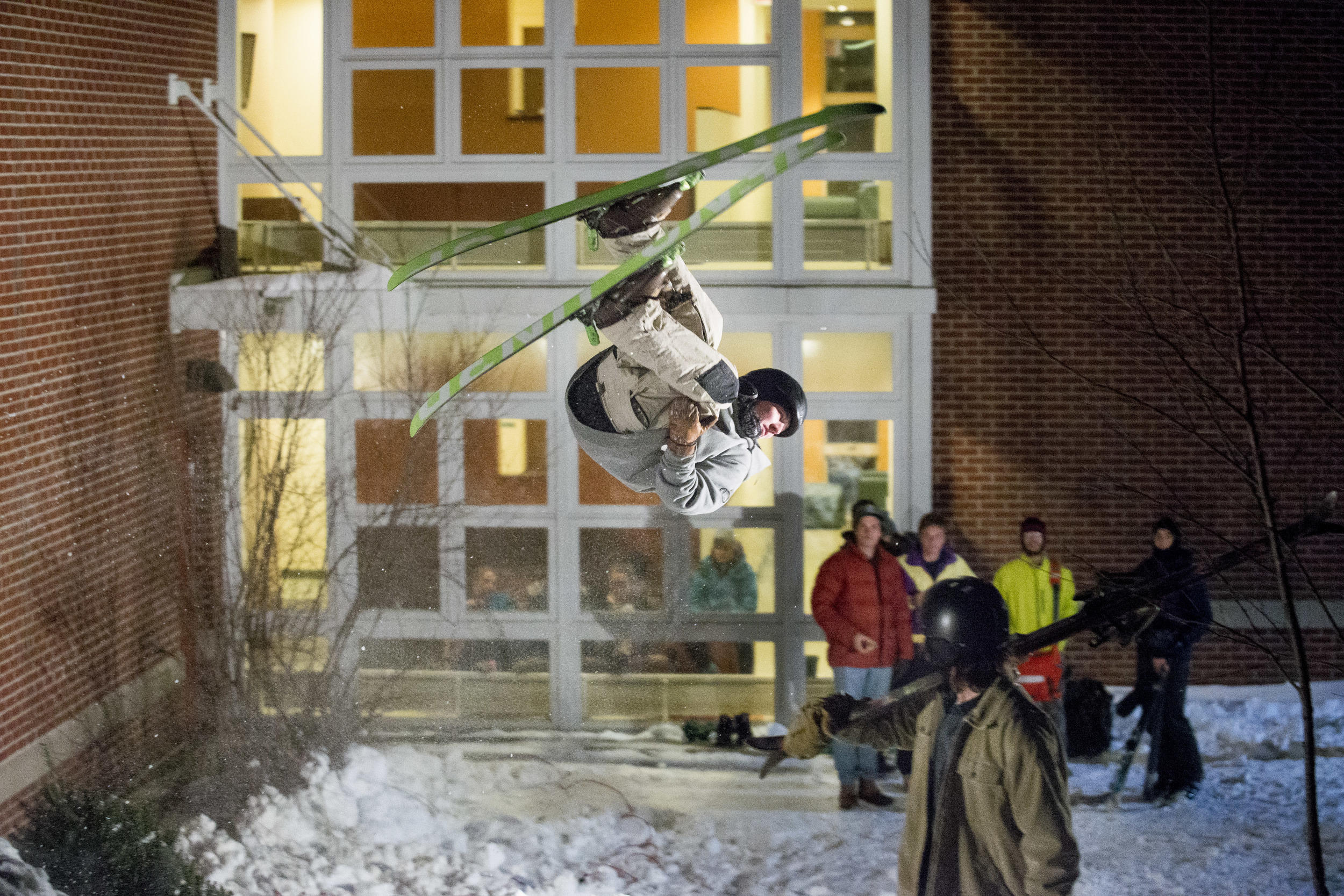 Patrick Sheils '19 of Portland, Maine eyes the landing for his flip at the base of Mt. David. The Bates Shred Club hosts "Skill 'N Grill," featuring a ski jump at the bottom of Mt. David behind 280 College Street as part of the 2016 Winter Carnival.