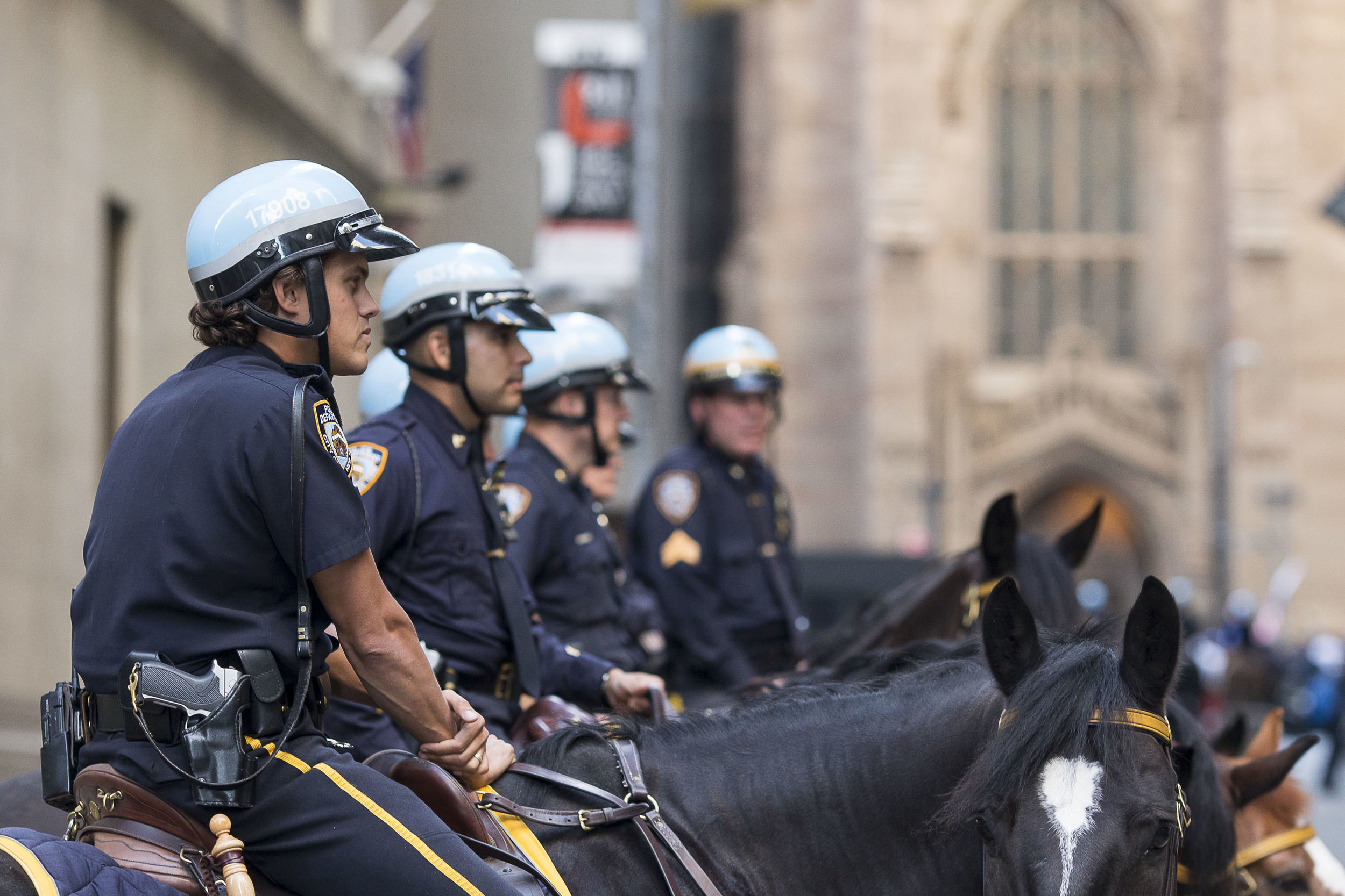  In anticipation of the protest, NYPD mounted patrolmen work to completely blockade the corner of Wall Street and Broad Street in front of the Stock Exchange. 