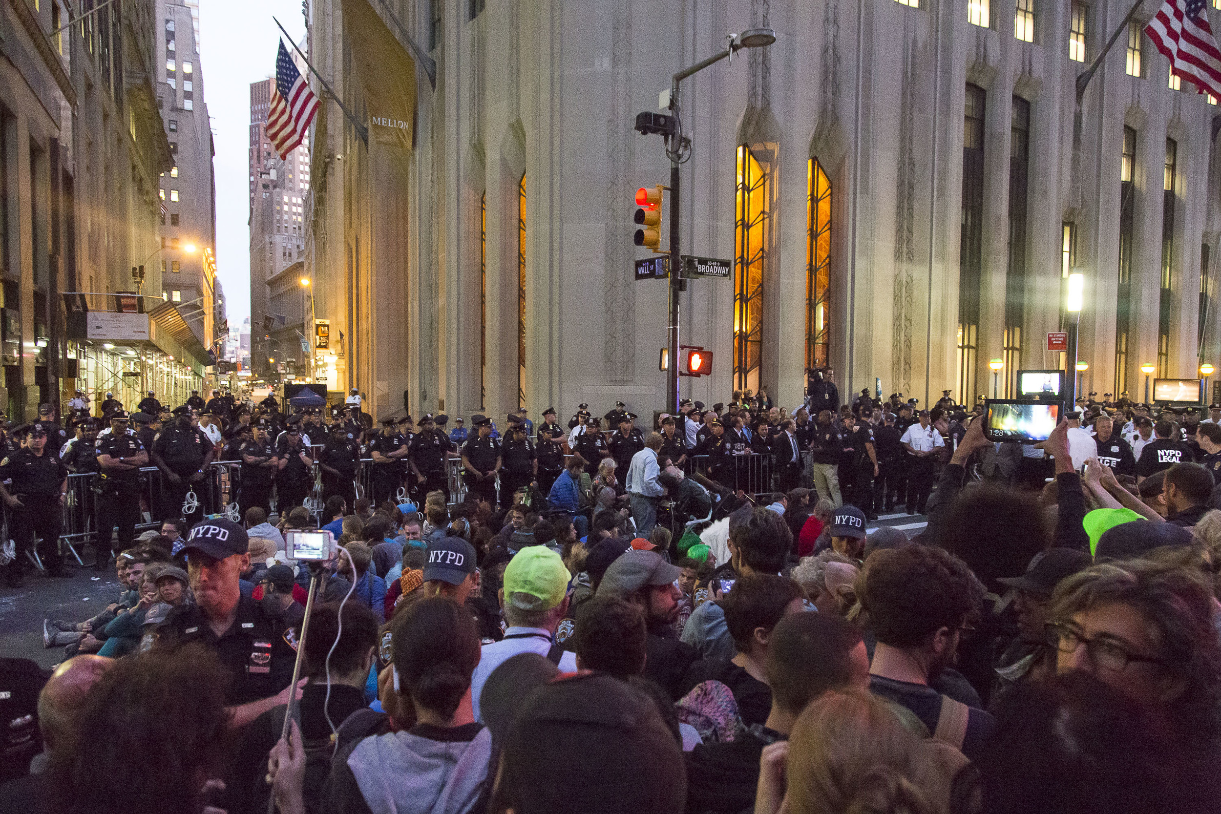  A small group of protestors, having refused to leave the street, are isolated by NYPD barriers in preparation for a group arrest. 