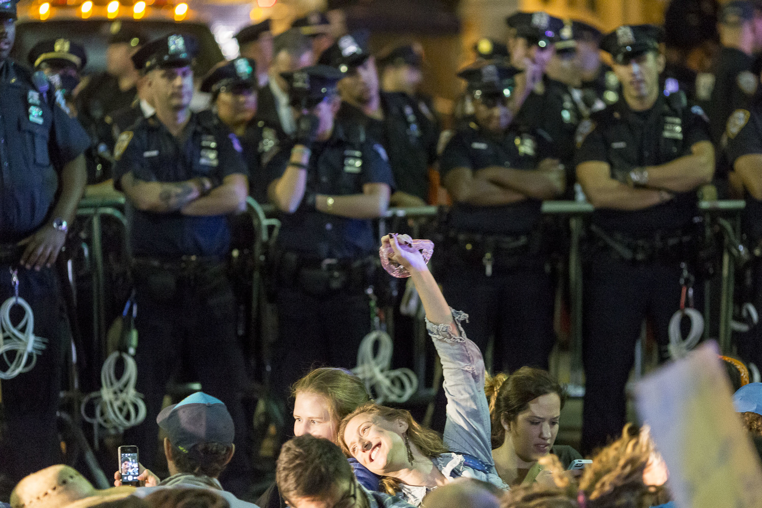 Protestors pose for a picture as the NYPD moves in for a group arrest.