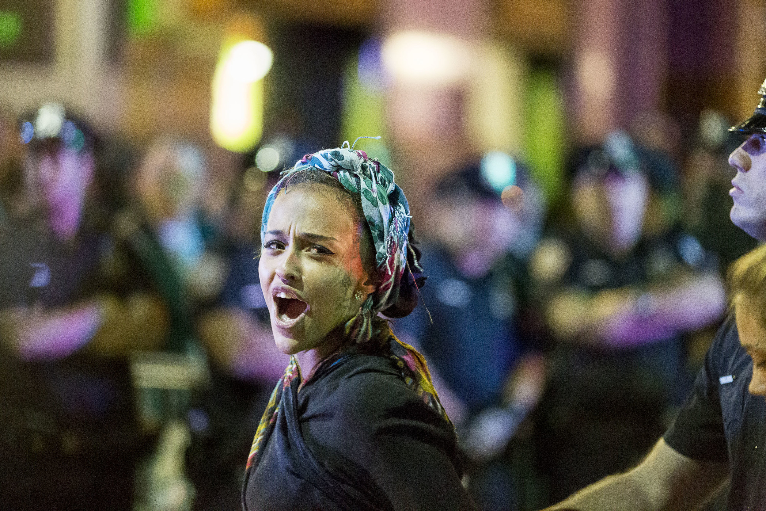  A protester responds to congratulations from friends in the crowd as she is arrested. 