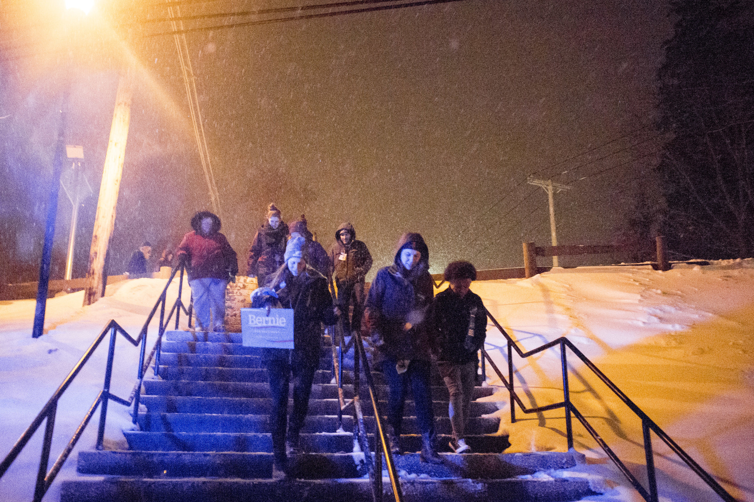 Sanders supporters head through the snow back to the parking lot following the rally.