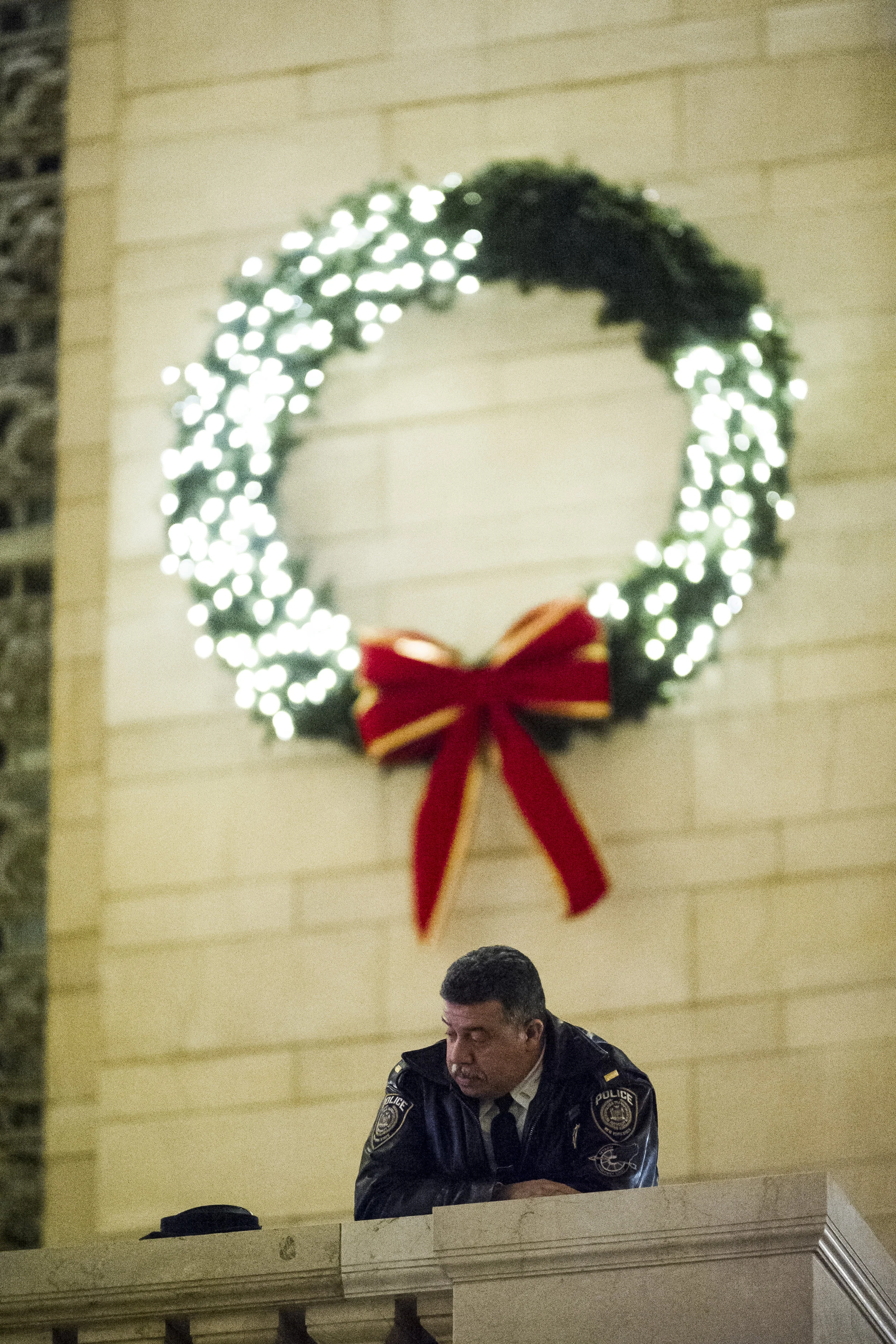 An NYPD officer looks on from above as demonstrators take part in a "die-in" in the main atrium of Grand Central Station. Weeks of protest followed a Staten Island grand jury's decision on December 3rd 2014 not to indict Officer Daniel Pantaleo in the killing of Eric Garner.