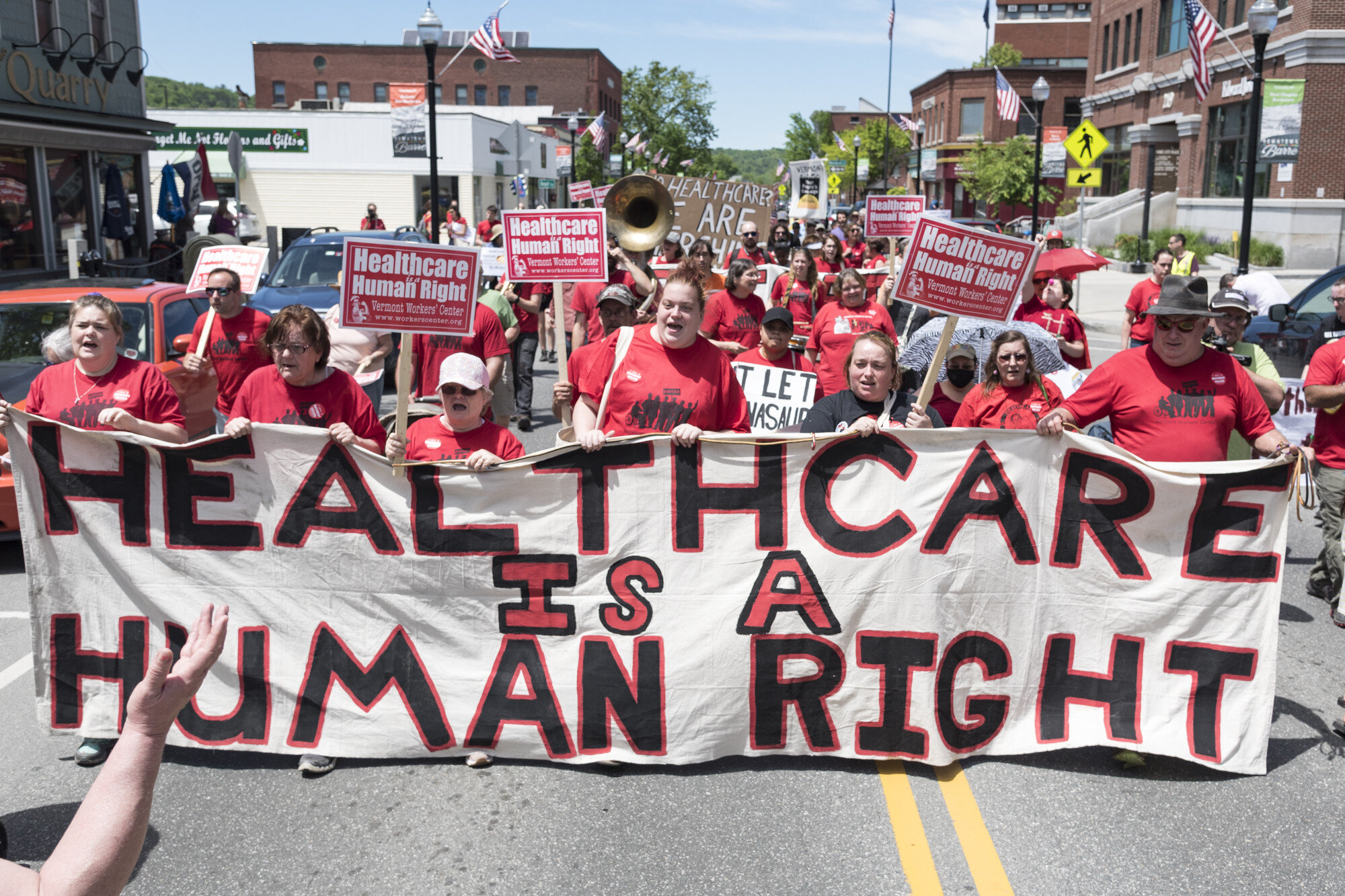  Demonstrators march down Main Street in downtown Barre, VT on Saturday, June 8th 2019 at the March for Medicaid, organized by the Vermont Workers' Center.  