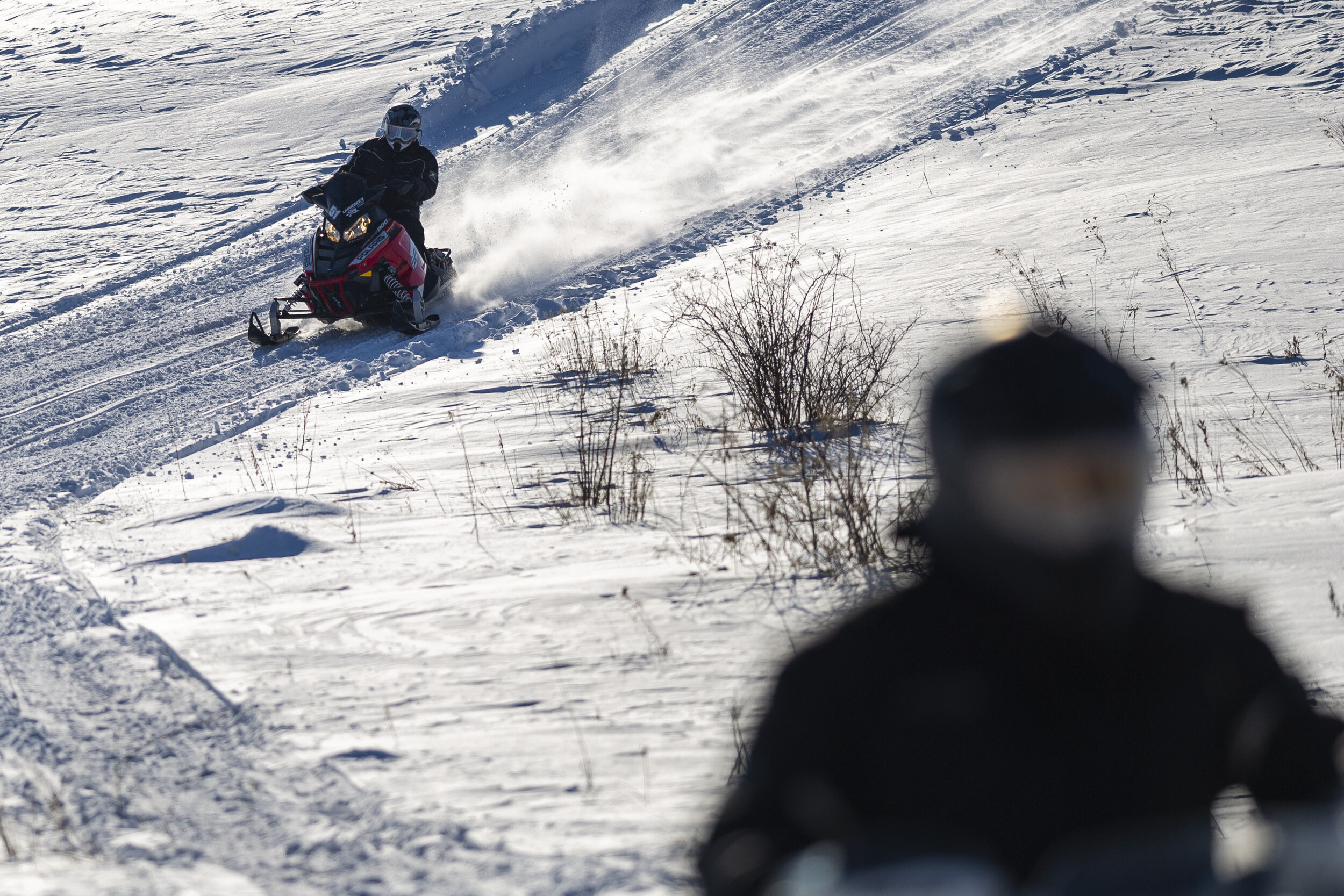  A pair of snowmobilers tear down a steep section of the VAST trail along Beckley Hill Road in Barre Town, VT on Saturday, February 22nd 2020.  