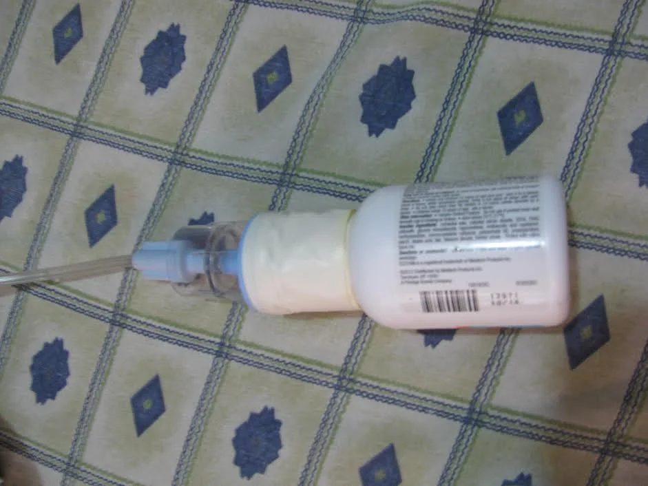 An empty aspirin bottle repurposed as a nebulizer