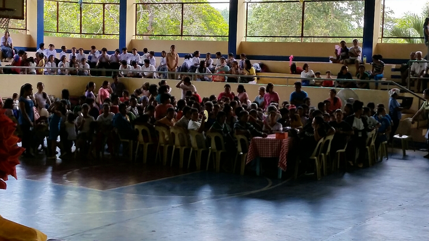 a corner of a large, filled gymnasium wanting, and needing, care