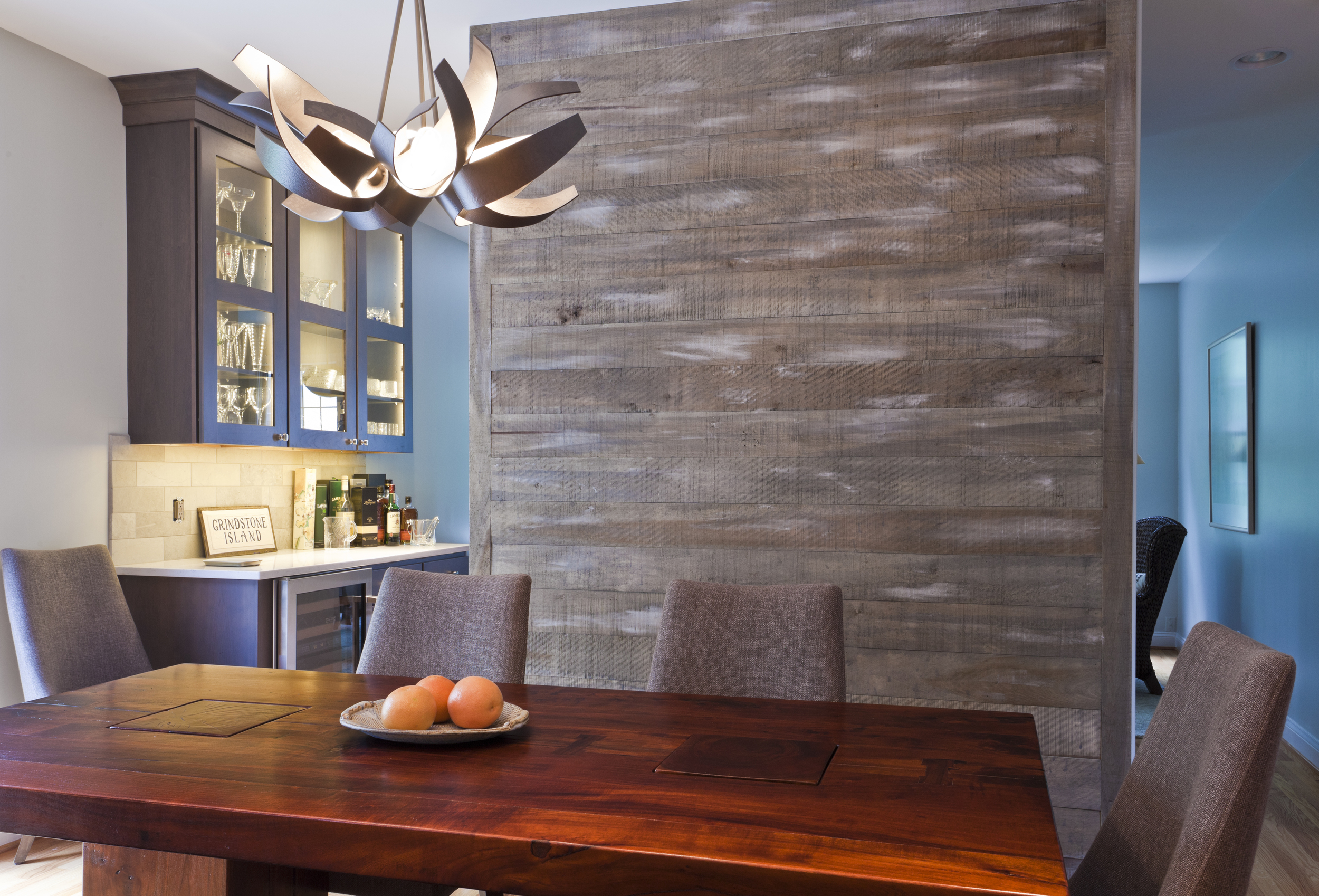 The cabinets complete the extension of the kitchen into the other room, enabling a clean flow.
