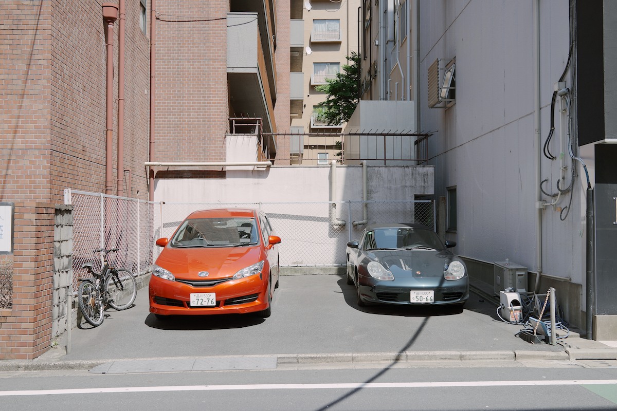 The Toyota Wish parked next to a Porsche Boxster.