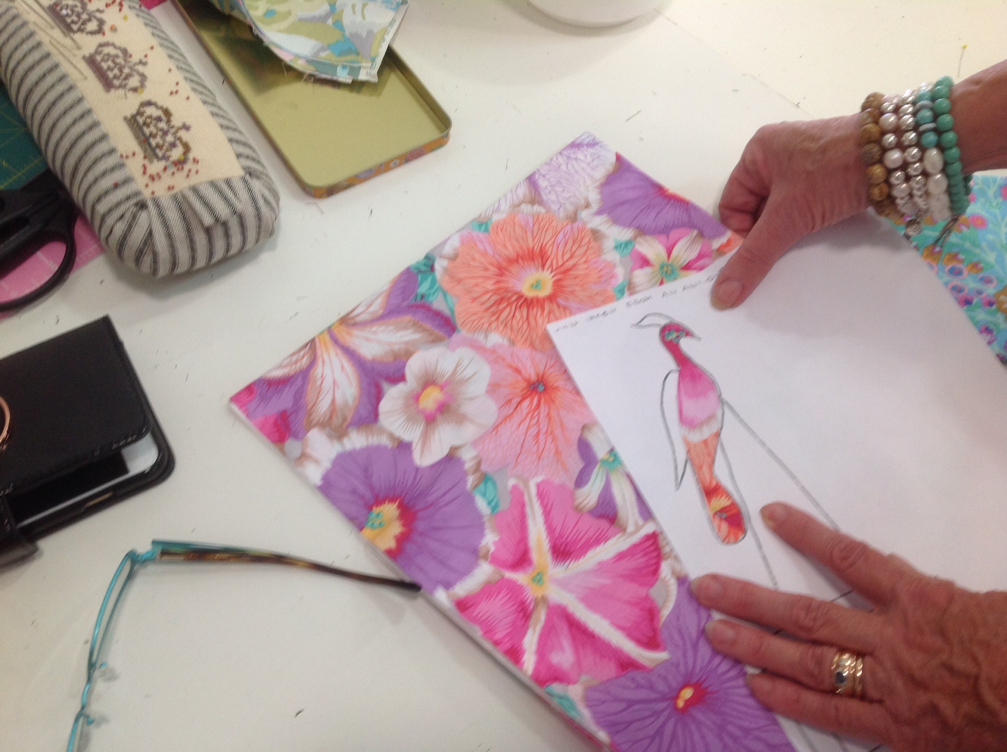 Marg's bird cut from paper to enable the ideal piece of fabric to be found to create him.