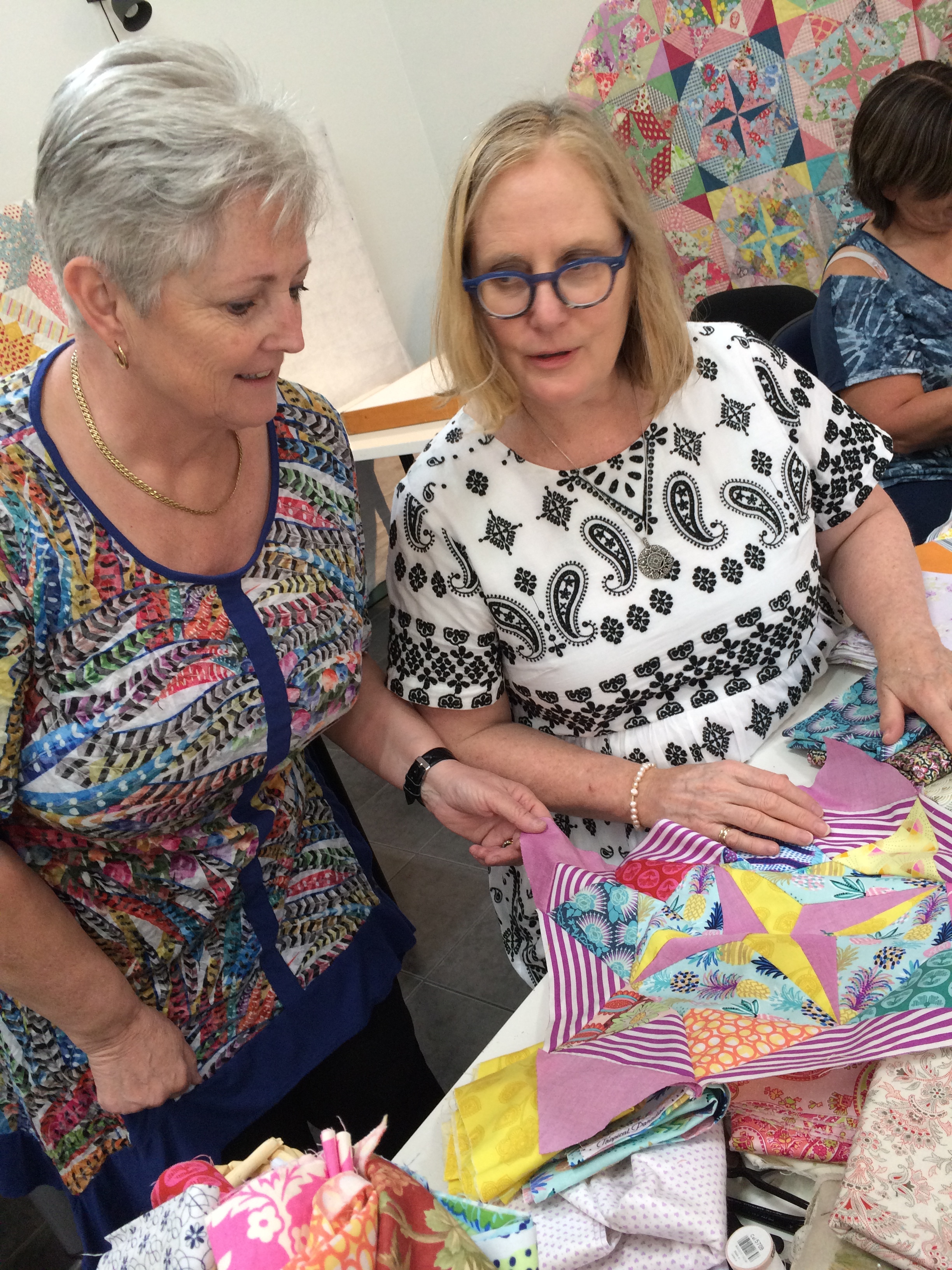 Here Judy (on the right) is helping Sue exclude some fabric choices. Sue's Mayfair block has some Victoria Finlay Wolfe fabric and some Anna Maria Horner too.
