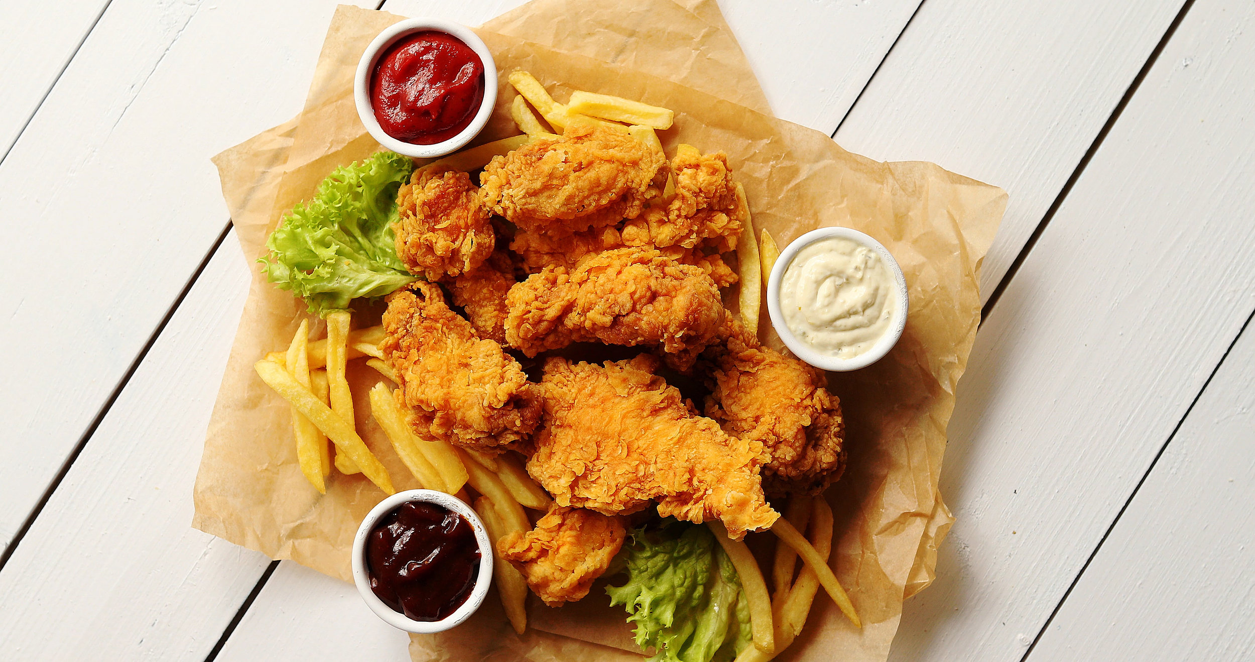 sauces-and-lettuce-near-french-fries-and-chicken-W4E6BNS.jpg