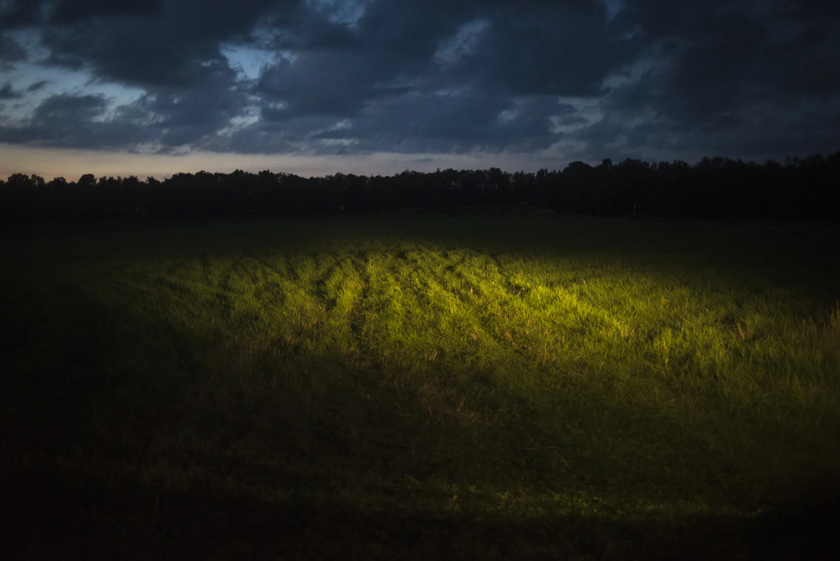 Truck headlights illuminate a field in Wyoming County where gas pipeline construction is underway.
