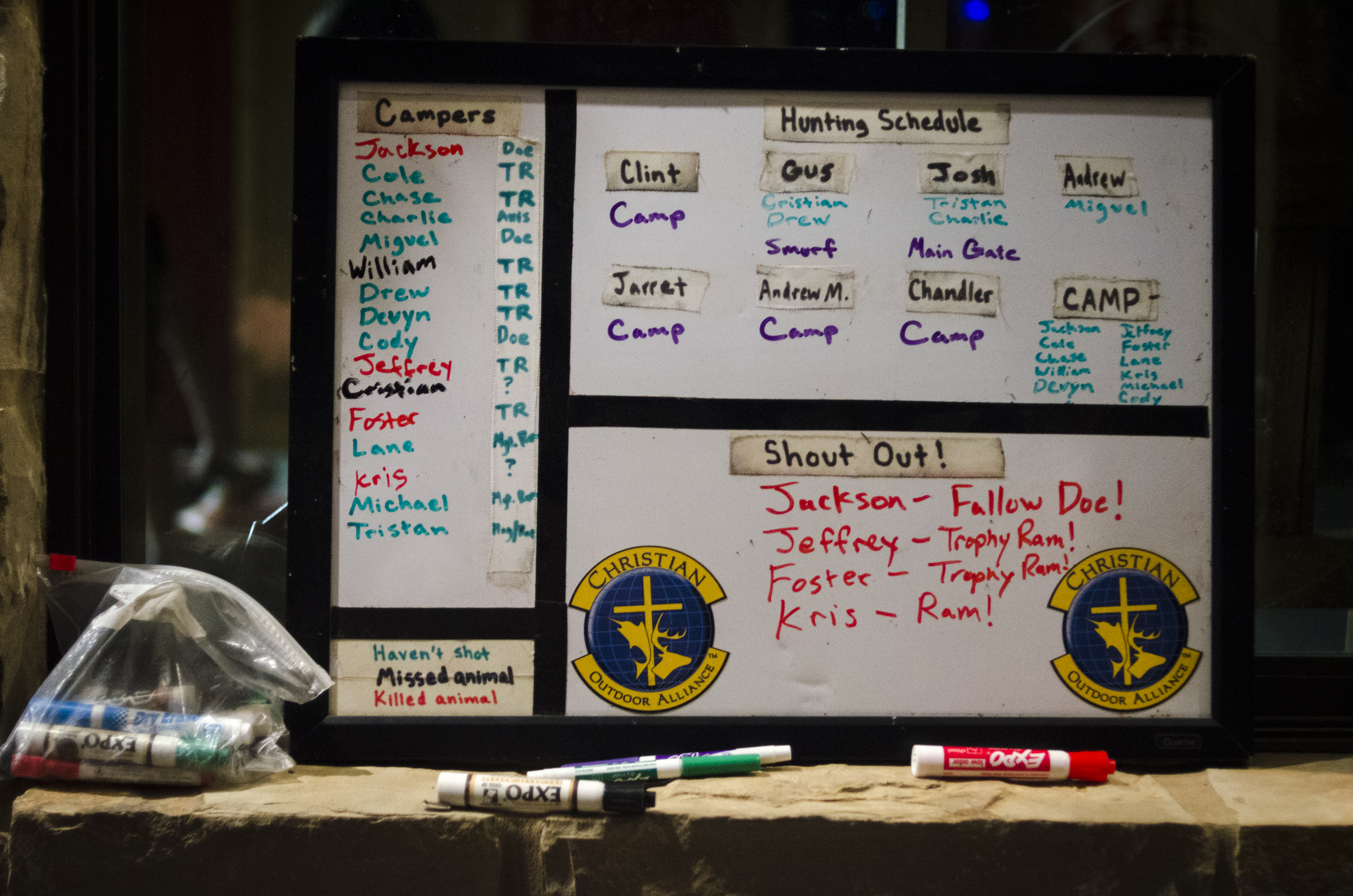 Counselors use a whiteboard to plan each day’s hunt and to keep track of the campers who have killed an animal during the week.