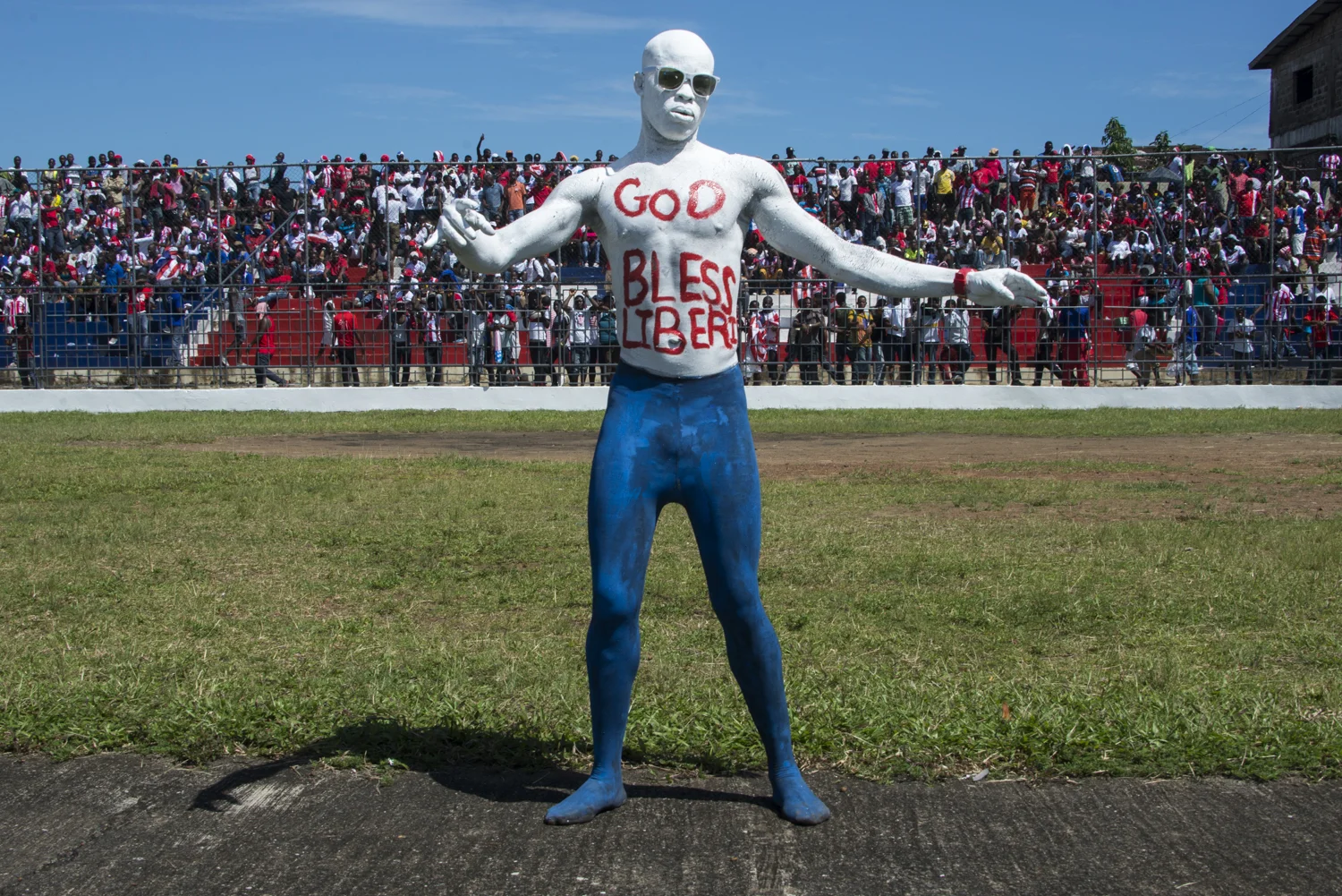 This story was originally published by The Player's Tribune on Oct. 29, 2015. When the Ebola outbreak occurred in Liberia in 2014, one of the biggest cultural impacts was the government’s decision last June to ban all soccer play in an effort to reduce to spread of the virus through physical contact. With the number of cases declining, the ban on soccer was lifted in January. Nearly 5,000 people died before the country was declared Ebola-free this past May. This summer, a three-day tournament took place in Logan Town, a community north of Monrovia, that consisted of both men’s soccer matches and women’s kick ball games. The tournament was played on a large, muddy patch of oddly-shaped common area, which included the only road into that part of Logan Town. As such, the goals (made out of netting and tree branches) were not placed directly opposite each other, and a large delivery truck drove across the field repeatedly interrupting play. A party-like atmosphere surrounded the event, with loud music playing and many people drinking cheap booze out of small plastic bottles. Younger kids watched the matches eagerly, jockeying for every opportunity to run after an out-of-bounds ball and throw it back into play. When the last soccer match came down to a penalty shootout, a thick mob of people formed around the goal. Team bragging rights and a small cash prize were on the line. The kick was good and celebrations could finally begin. On Oct. 8, 2015 Liberia’s national team, the Lone Stars, played Guinea-Bissau in a FIFA World Cup Qualifying match, which was held on a regulation field at Antoinette Tubman Stadium in central Monrovia. Following the Ebola outbreak and the ban of soccer in the country in 2014, the stadium was converted for use as an Ebola Treatment Unit. Now back to it’s originally intended use, rowdy, celebrating Liberians packed the stadium for the match, which ended in a 1-1 tie. A week later, Liberia pulled off an unexpected win against Guinea-Bissau. Liberia is now scheduled to play Ivory Coast in a second-round qualifying match on Nov. 11. “If Liberia loses, there will be a riot,” one fan said. “If we win, there will still probably be a riot.”