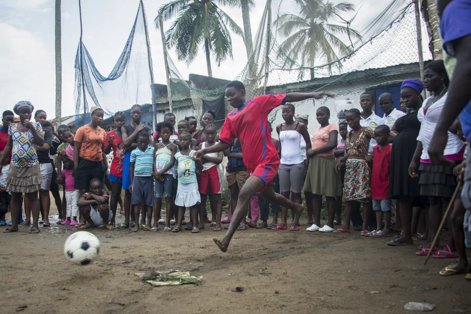 This story was originally published by The Player's Tribune on Oct. 29, 2015. When the Ebola outbreak occurred in Liberia in 2014, one of the biggest cultural impacts was the government’s decision last June to ban all soccer play in an effort to reduce to spread of the virus through physical contact. With the number of cases declining, the ban on soccer was lifted in January. Nearly 5,000 people died before the country was declared Ebola-free this past May. This summer, a three-day tournament took place in Logan Town, a community north of Monrovia, that consisted of both men’s soccer matches and women’s kick ball games. The tournament was played on a large, muddy patch of oddly-shaped common area, which included the only road into that part of Logan Town. As such, the goals (made out of netting and tree branches) were not placed directly opposite each other, and a large delivery truck drove across the field repeatedly interrupting play. A party-like atmosphere surrounded the event, with loud music playing and many people drinking cheap booze out of small plastic bottles. Younger kids watched the matches eagerly, jockeying for every opportunity to run after an out-of-bounds ball and throw it back into play. When the last soccer match came down to a penalty shootout, a thick mob of people formed around the goal. Team bragging rights and a small cash prize were on the line. The kick was good and celebrations could finally begin. On Oct. 8, 2015 Liberia’s national team, the Lone Stars, played Guinea-Bissau in a FIFA World Cup Qualifying match, which was held on a regulation field at Antoinette Tubman Stadium in central Monrovia. Following the Ebola outbreak and the ban of soccer in the country in 2014, the stadium was converted for use as an Ebola Treatment Unit. Now back to it’s originally intended use, rowdy, celebrating Liberians packed the stadium for the match, which ended in a 1-1 tie. A week later, Liberia pulled off an unexpected win against Guinea-Bissau. Liberia is now scheduled to play Ivory Coast in a second-round qualifying match on Nov. 11. “If Liberia loses, there will be a riot,” one fan said. “If we win, there will still probably be a riot.”