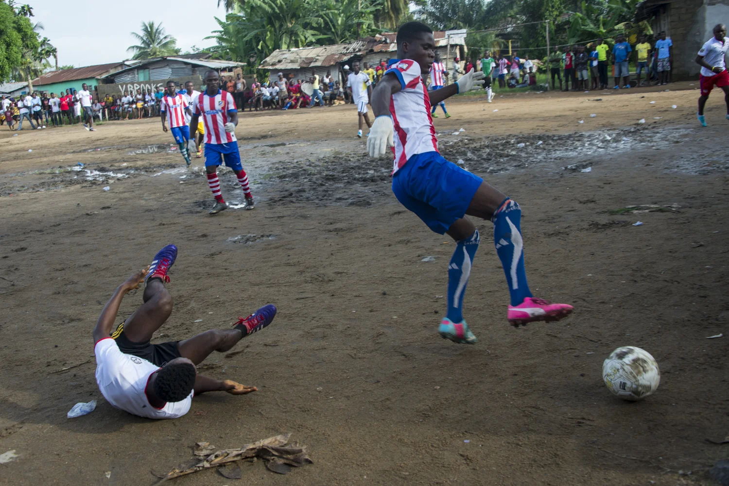 This story was originally published by The Player's Tribune on Oct. 29, 2015. When the Ebola outbreak occurred in Liberia in 2014, one of the biggest cultural impacts was the government’s decision last June to ban all soccer play in an effort to reduce to spread of the virus through physical contact. With the number of cases declining, the ban on soccer was lifted in January. Nearly 5,000 people died before the country was declared Ebola-free this past May. This summer, a three-day tournament took place in Logan Town, a community north of Monrovia, that consisted of both men’s soccer matches and women’s kick ball games. The tournament was played on a large, muddy patch of oddly-shaped common area, which included the only road into that part of Logan Town. As such, the goals (made out of netting and tree branches) were not placed directly opposite each other, and a large delivery truck drove across the field repeatedly interrupting play. A party-like atmosphere surrounded the event, with loud music playing and many people drinking cheap booze out of small plastic bottles. Younger kids watched the matches eagerly, jockeying for every opportunity to run after an out-of-bounds ball and throw it back into play. When the last soccer match came down to a penalty shootout, a thick mob of people formed around the goal. Team bragging rights and a small cash prize were on the line. The kick was good and celebrations could finally begin. On Oct. 8, 2015 Liberia’s national team, the Lone Stars, played Guinea-Bissau in a FIFA World Cup Qualifying match, which was held on a regulation field at Antoinette Tubman Stadium in central Monrovia. Following the Ebola outbreak and the ban of soccer in the country in 2014, the stadium was converted for use as an Ebola Treatment Unit. Now back to it’s originally intended use, rowdy, celebrating Liberians packed the stadium for the match, which ended in a 1-1 tie. A week later, Liberia pulled off an unexpected win against Guinea-Bissau. Liberia is now scheduled to play Ivory Coast in a second-round qualifying match on Nov. 11. “If Liberia loses, there will be a riot,” one fan said. “If we win, there will still probably be a riot.”