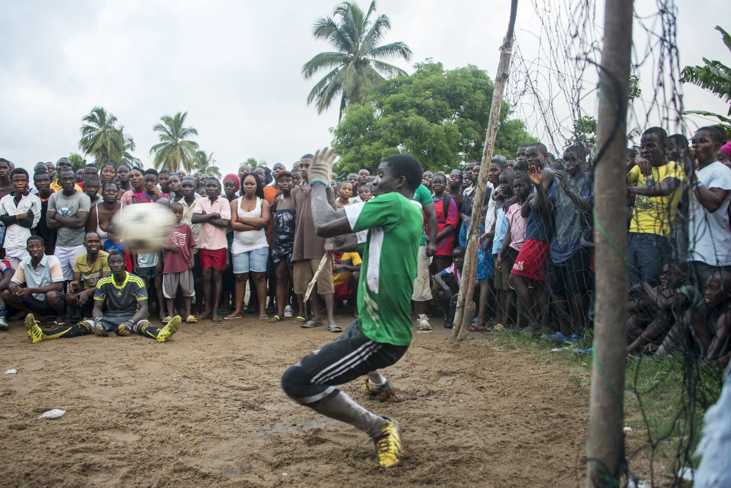 This story was originally published by The Player's Tribune on Oct. 29, 2015. When the Ebola outbreak occurred in Liberia in 2014, one of the biggest cultural impacts was the government’s decision last June to ban all soccer play in an effort to reduce to spread of the virus through physical contact. With the number of cases declining, the ban on soccer was lifted in January. Nearly 5,000 people died before the country was declared Ebola-free this past May. This summer, a three-day tournament took place in Logan Town, a community north of Monrovia, that consisted of both men’s soccer matches and women’s kick ball games. The tournament was played on a large, muddy patch of oddly-shaped common area, which included the only road into that part of Logan Town. As such, the goals (made out of netting and tree branches) were not placed directly opposite each other, and a large delivery truck drove across the field repeatedly interrupting play. A party-like atmosphere surrounded the event, with loud music playing and many people drinking cheap booze out of small plastic bottles. Younger kids watched the matches eagerly, jockeying for every opportunity to run after an out-of-bounds ball and throw it back into play. When the last soccer match came down to a penalty shootout, a thick mob of people formed around the goal. Team bragging rights and a small cash prize were on the line. The kick was good and celebrations could finally begin. On Oct. 8, 2015 Liberia’s national team, the Lone Stars, played Guinea-Bissau in a FIFA World Cup Qualifying match, which was held on a regulation field at Antoinette Tubman Stadium in central Monrovia. Following the Ebola outbreak and the ban of soccer in the country in 2014, the stadium was converted for use as an Ebola Treatment Unit. Now back to it’s originally intended use, rowdy, celebrating Liberians packed the stadium for the match, which ended in a 1-1 tie. A week later, Liberia pulled off an unexpected win against Guinea-Bissau. Liberia is now scheduled to play Ivory Coast in a second-round qualifying match on Nov. 11. “If Liberia loses, there will be a riot,” one fan said. “If we win, there will still probably be a riot.”