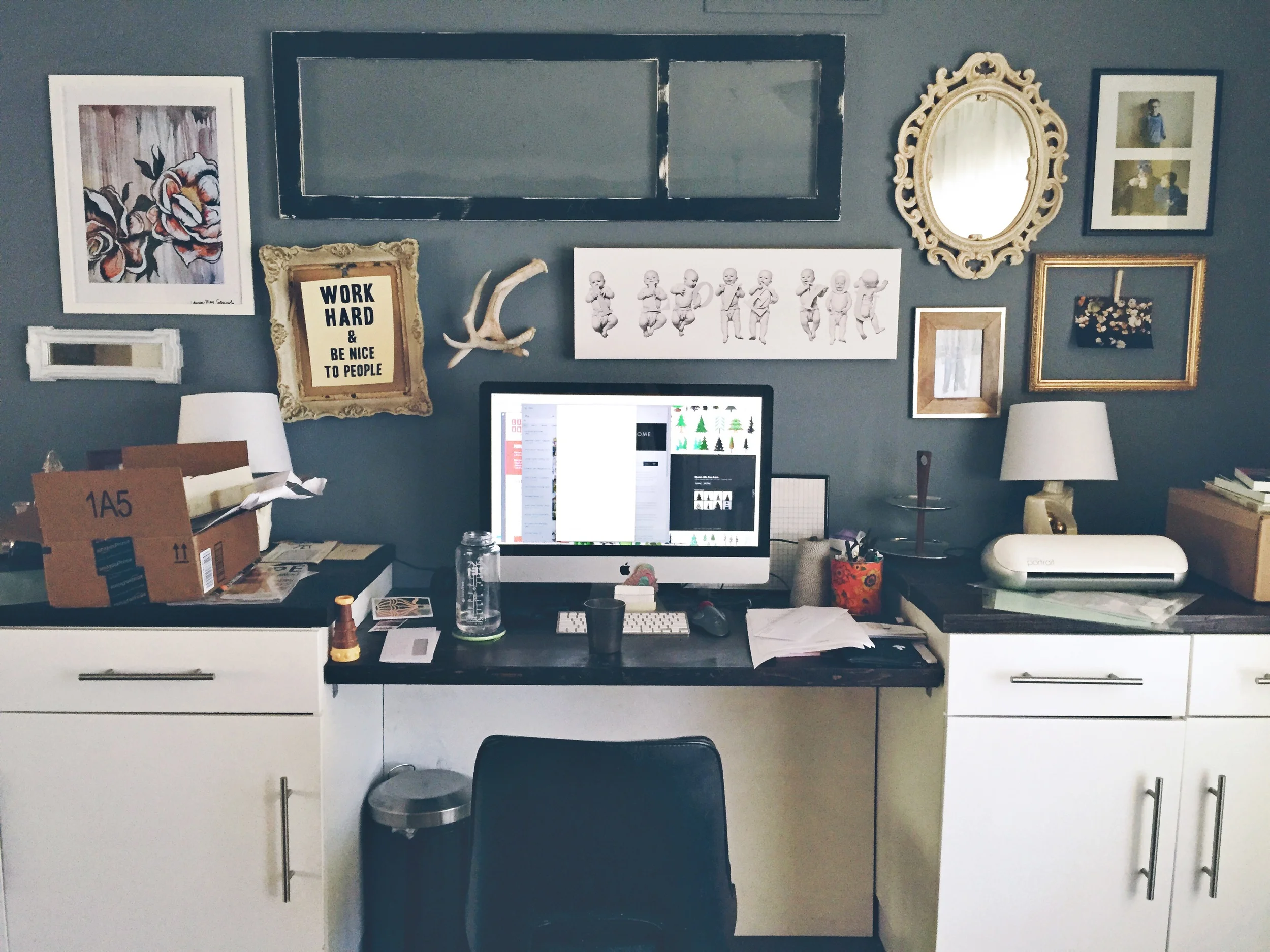 My real-life "messy desk". Yes, the crooked frame is killing me. And notice that Child #2 has yet to make an appearance on the wall. There are prints of her- they just haven't been hung yet. :)