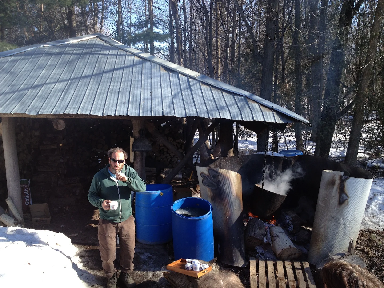 Farm owner Ian Walker explaining the process of Maple syrup production beside his cauldron of boiling sap.