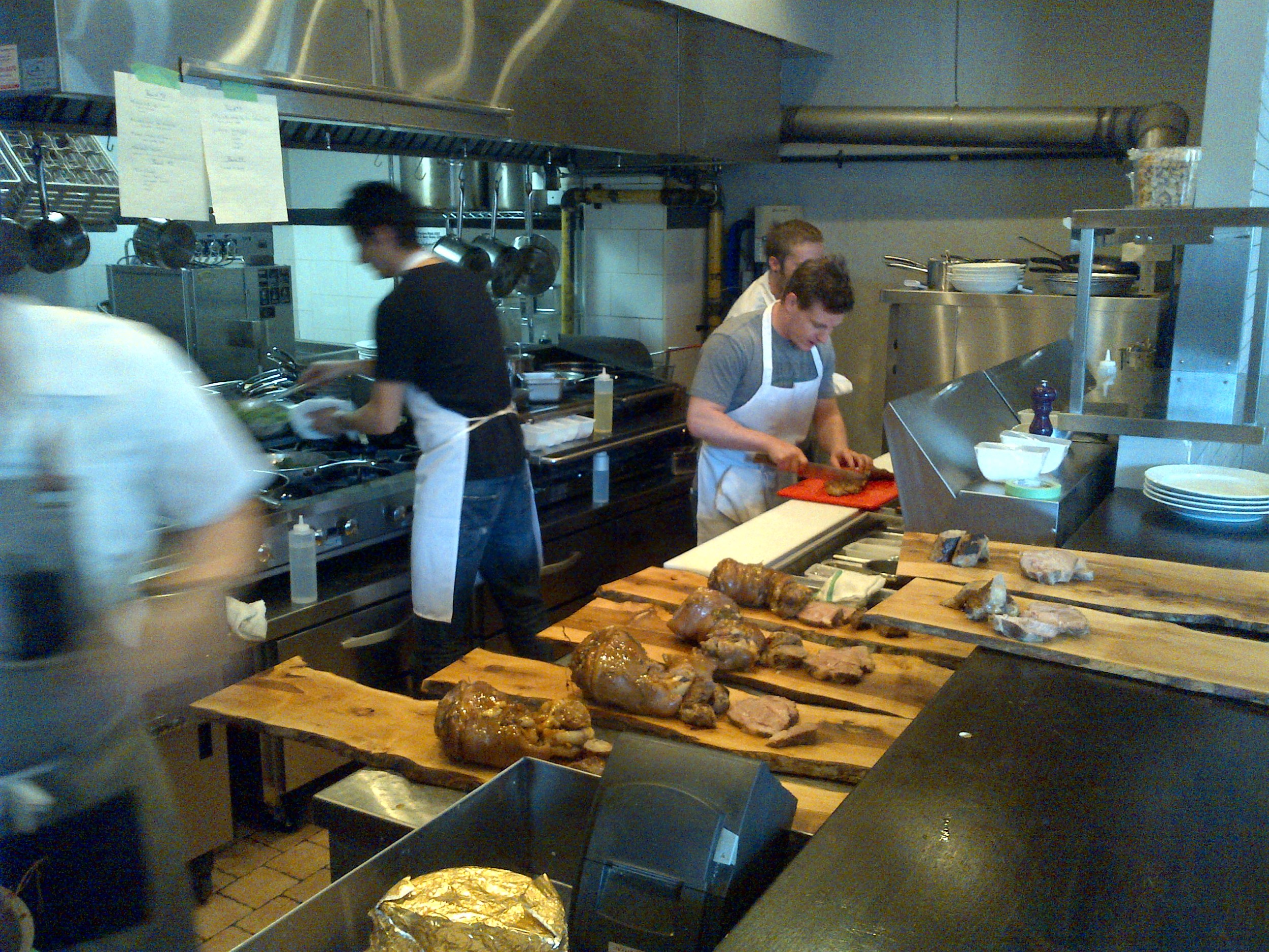  Steve Wall and his team at Supply and Demand plating (or wooding?) the pork on long wood planks for sharing plates.​ 