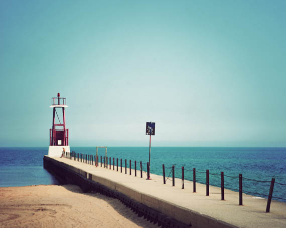 A lone beachgoer enjoying the beautiful blues of Lake Michigan