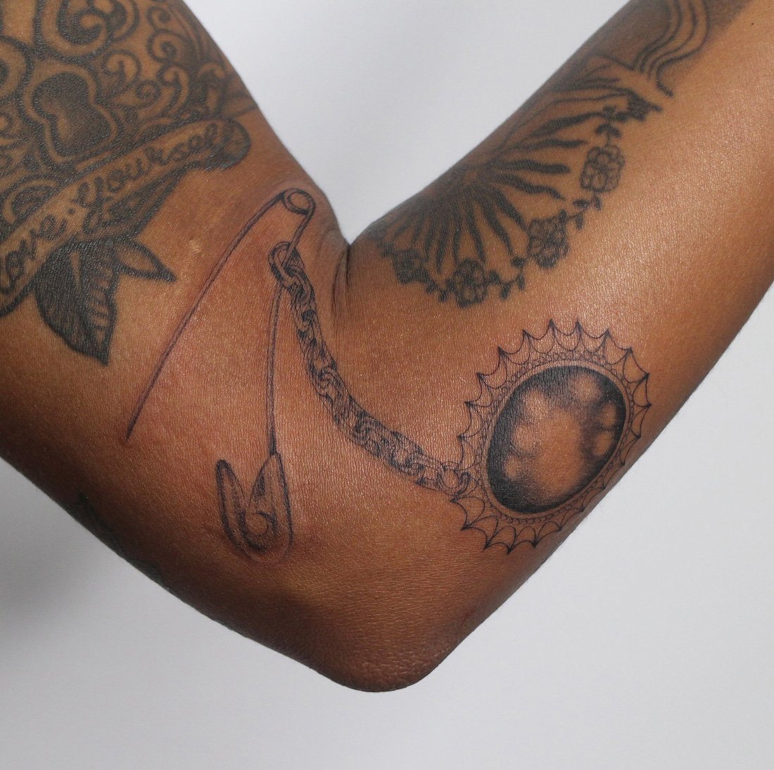jewel safety pin elbow Jacqueline may tattoo art.jpeg