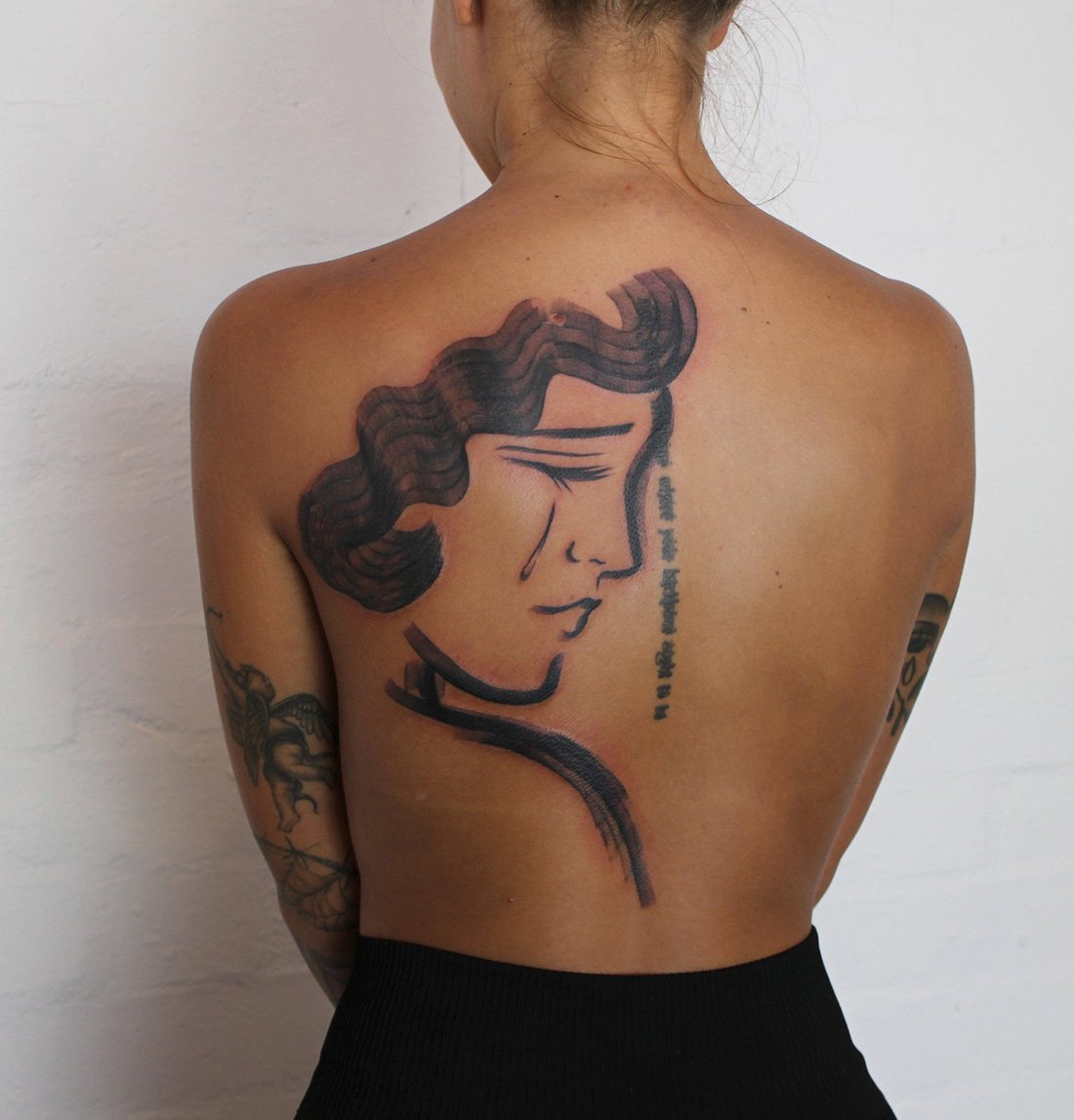 minimalist female face back piece woman simple bold mag drag Jacqueline may tattoo art black and grey toronto artist.jpeg